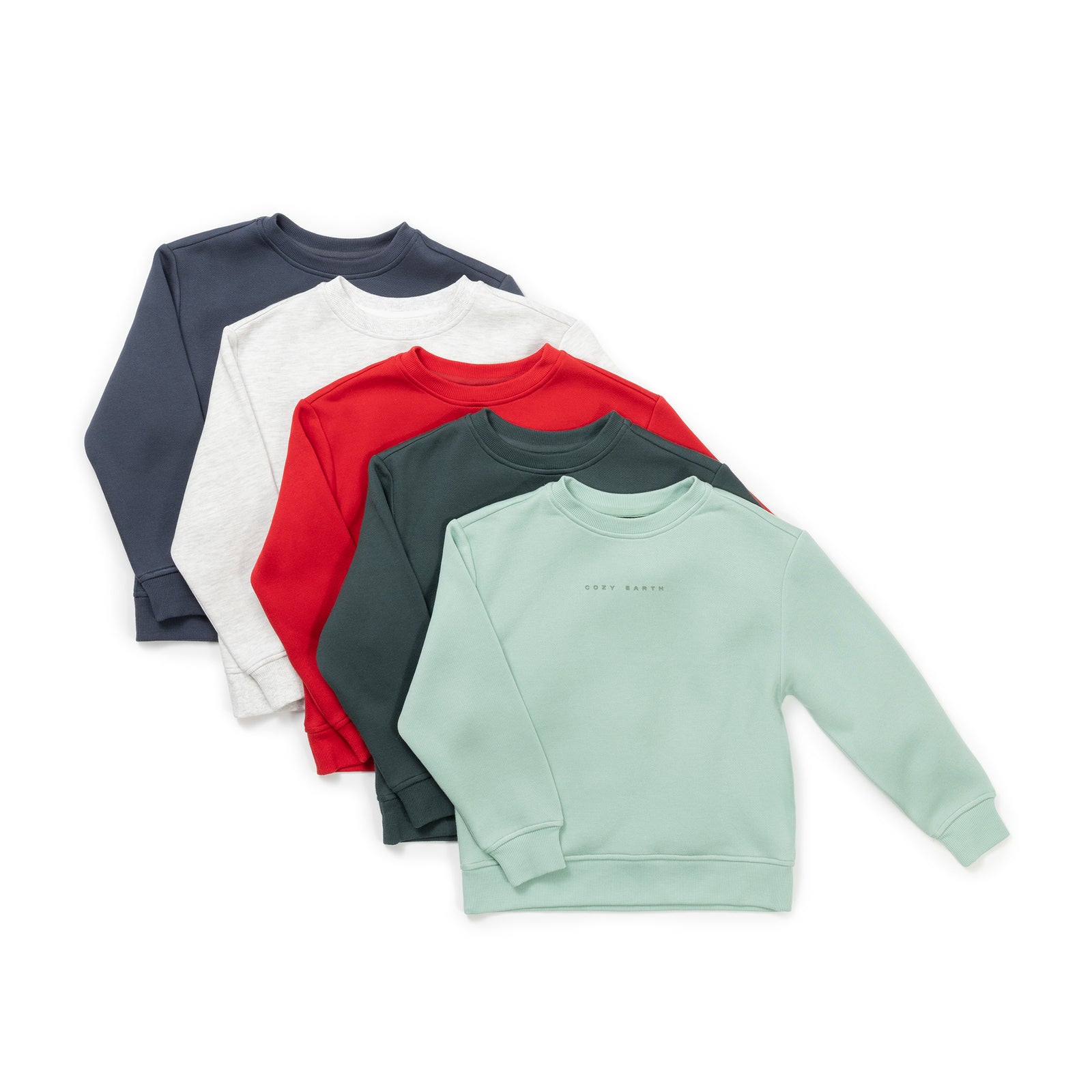 Four Kid's CityScape Crewnecks from Cozy Earth, in shades of green, red, white, and dark gray, are laid out in a fanned arrangement. 