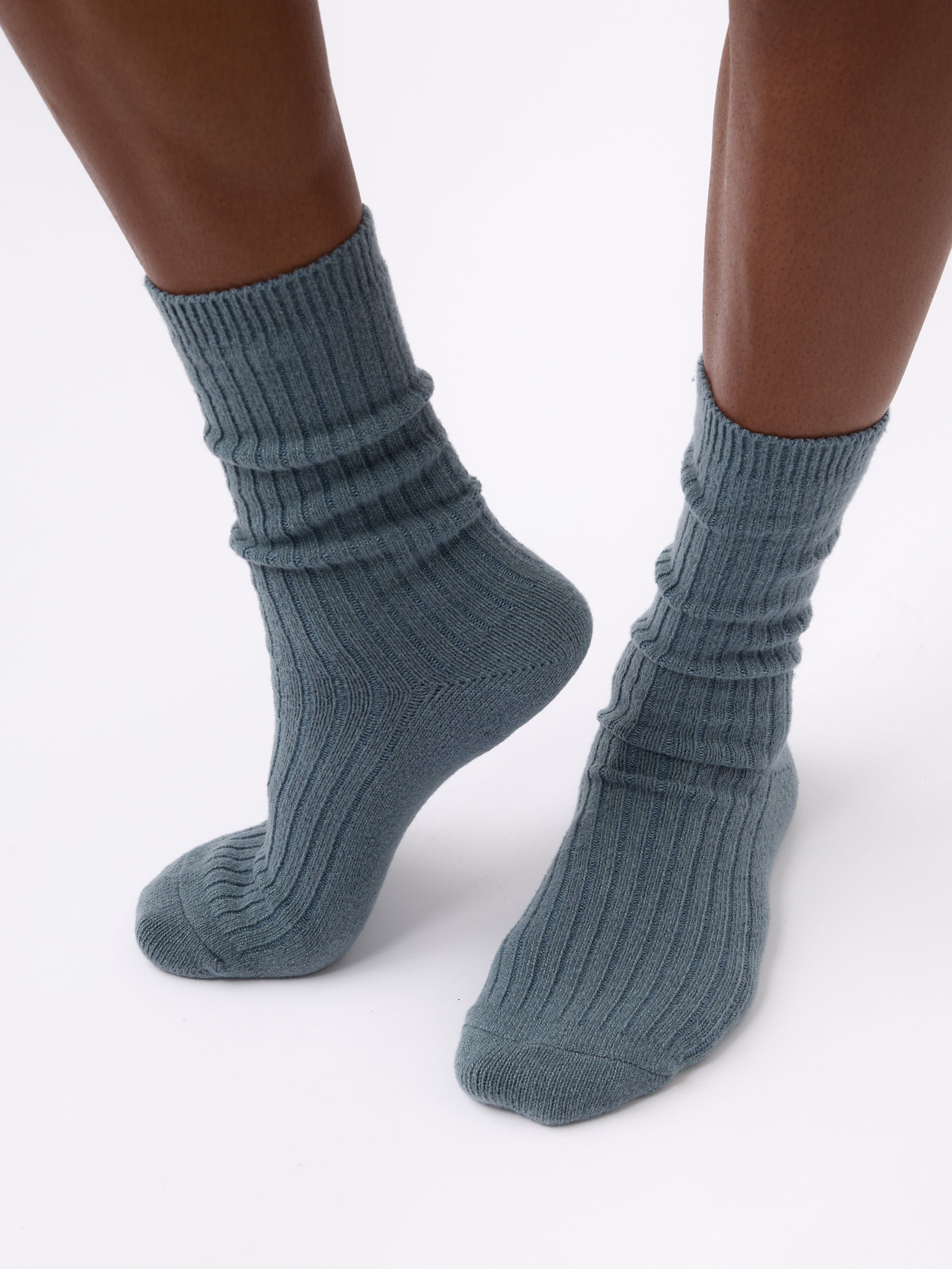 Person wearing Cozy Earth Plush Lounge Sock in Deep Blue 