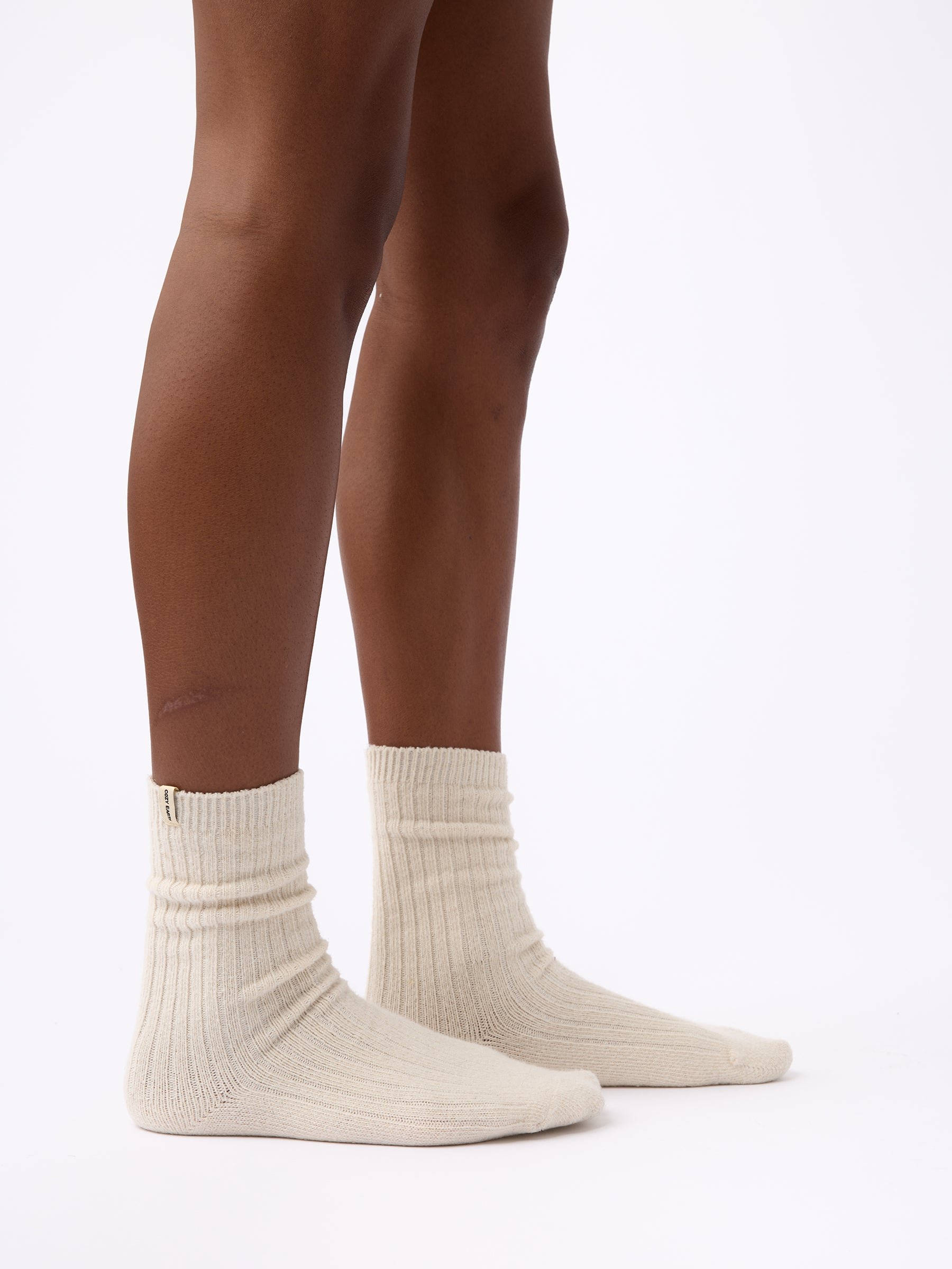 Person wearing Cozy Earth Plush Lounge Sock in Alabaster 