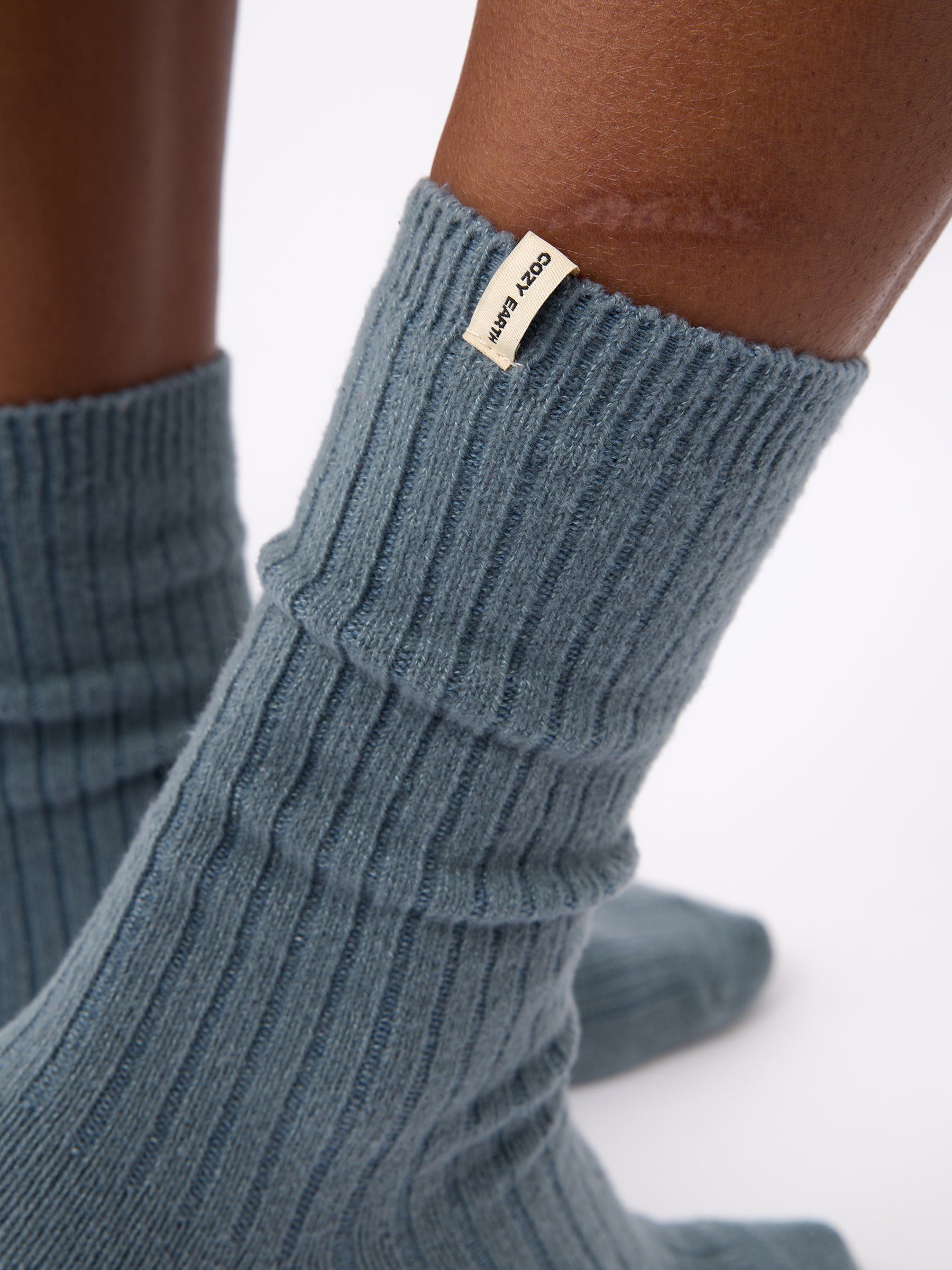 Close-up of tag on Cozy Earth Plush Lounge Sock in Deep Blue 