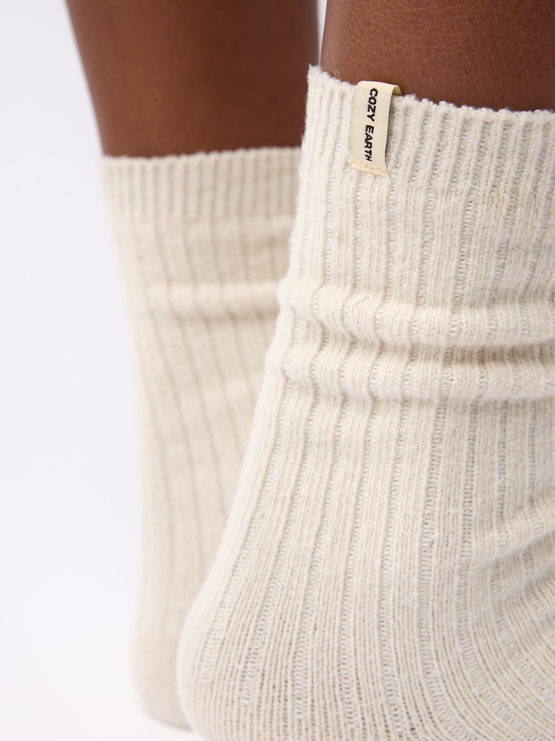 Close-up of tag on Cozy Earth Plush Lounge Sock in Alabaster 