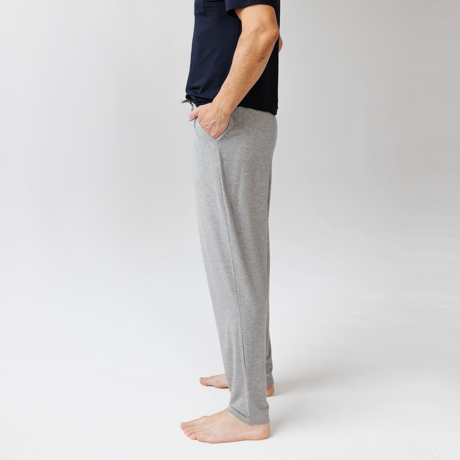 Side view of man in heather grey pajama pants with white background 