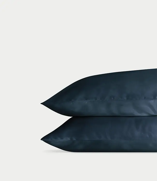 Two navy pillowcases with a plain background standard/king/body