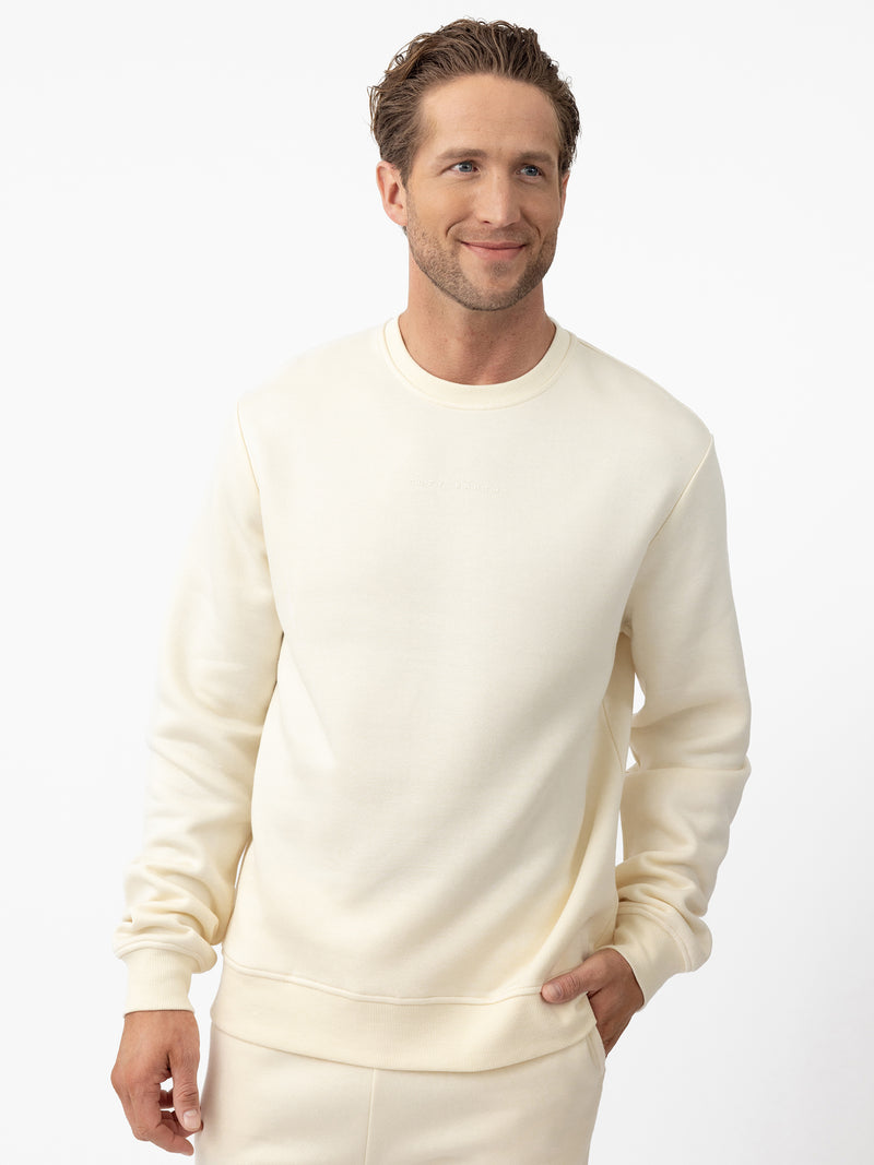 Man wearing Alabaster cityscape crewneck with white background