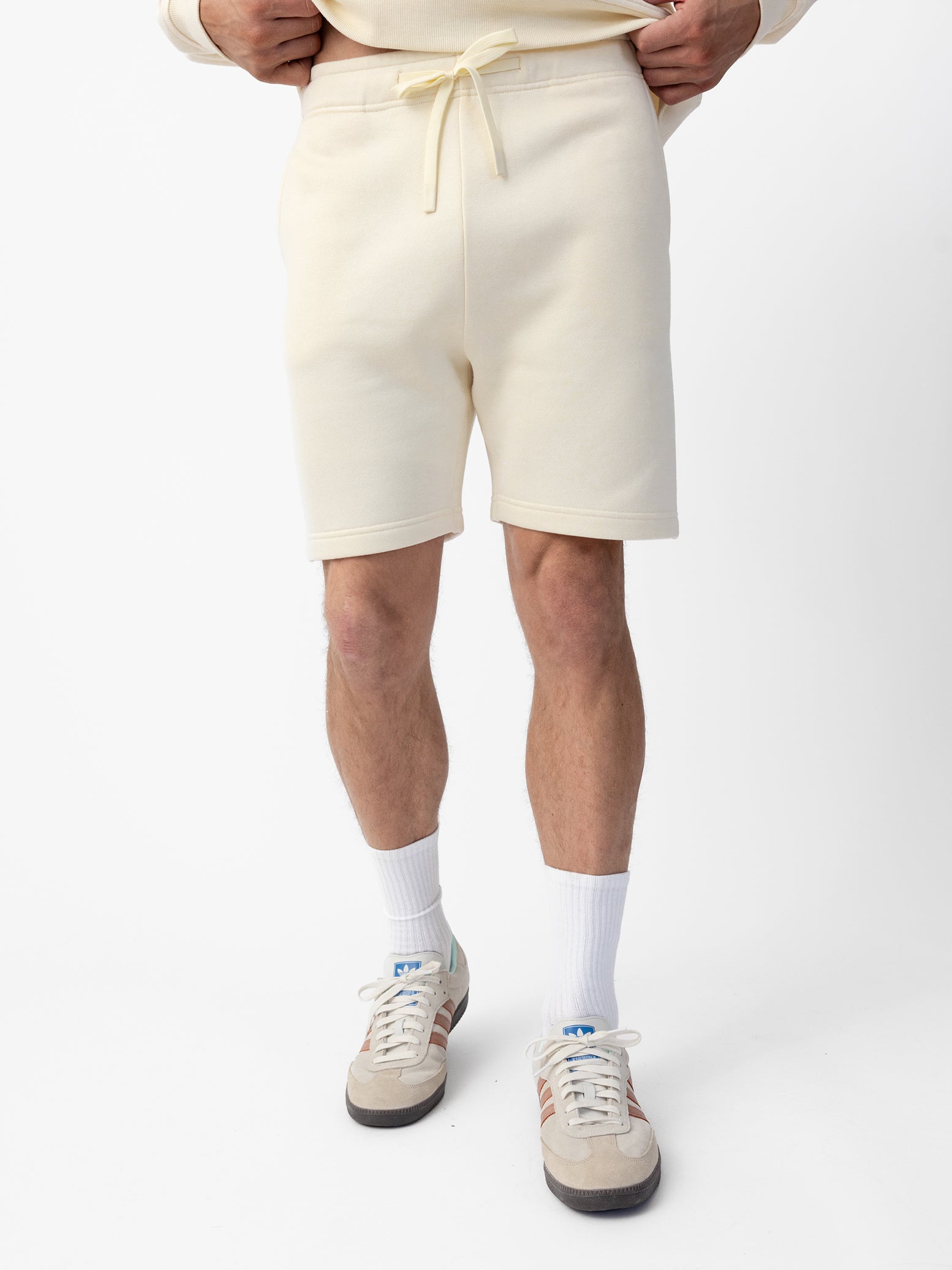 Man wearing Alabaster CityScape Shorts with white background 