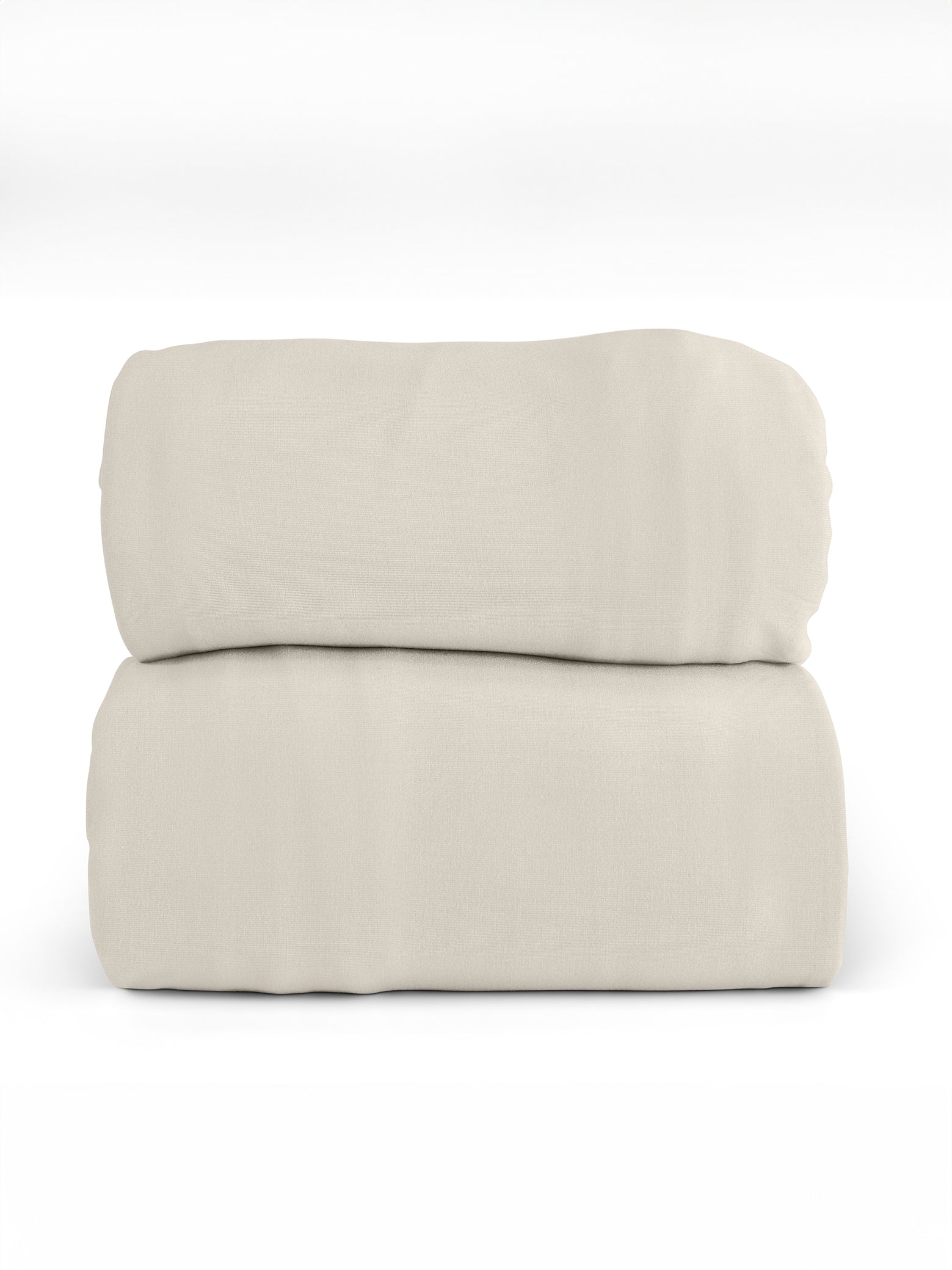 A neatly folded, light beige Bamboo Jersey Sheet Set from Cozy Earth is placed against a plain white background. The fabric appears smooth and soft, creating a simple and minimalist composition. |Color:Birch