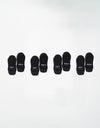 Four pairs of black Essential Ankle Socks by Cozy Earth are arranged in a row on a white background, each pair featuring "COZY" and "EARTH" in white text on the toes. |Color:Black