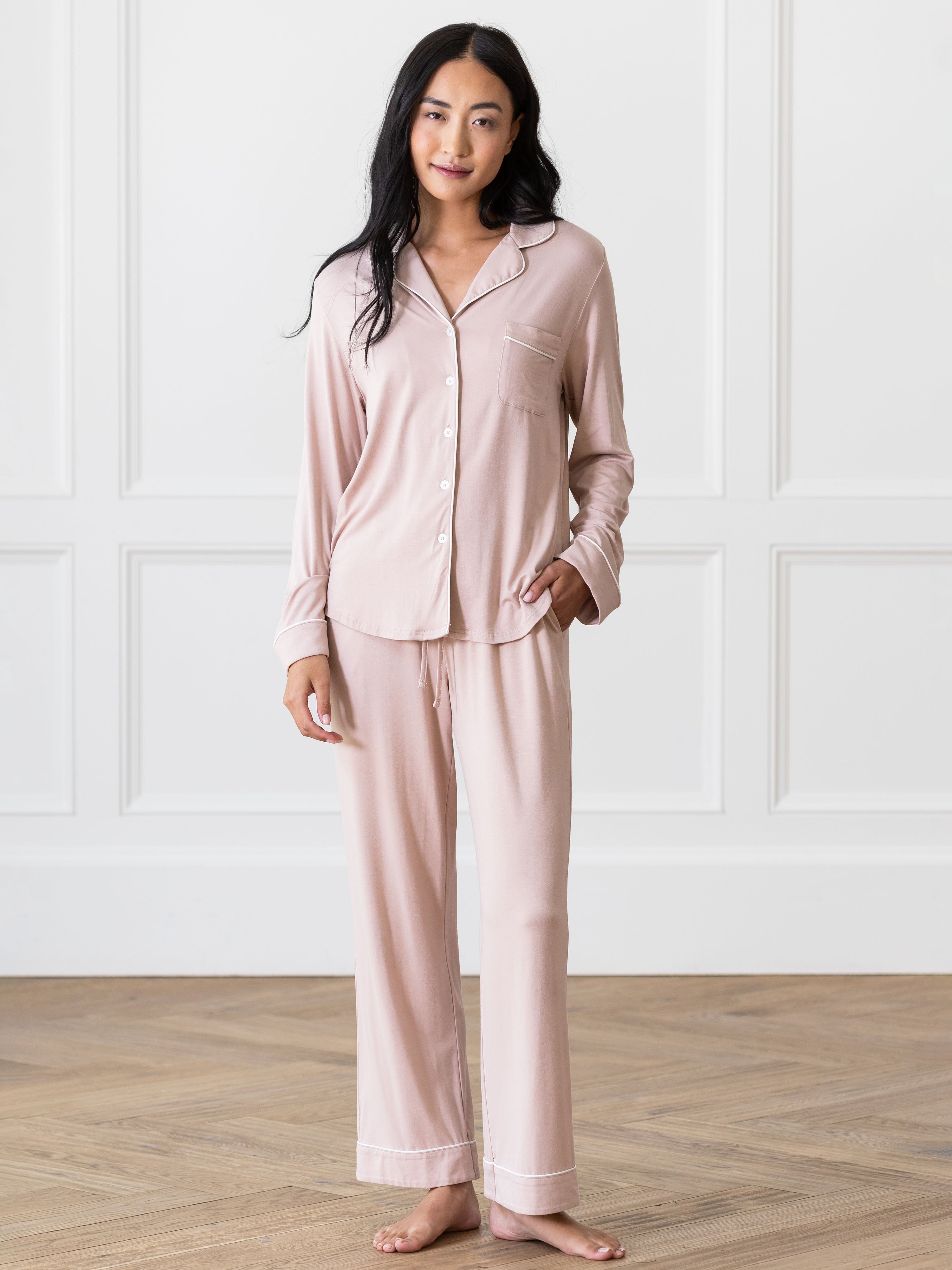 Blush Long Sleeve Pajama Set modeled by a woman. The photo was taken in a high contrast setting, showing off the colors and lines of the pajamas. |Color:Blush