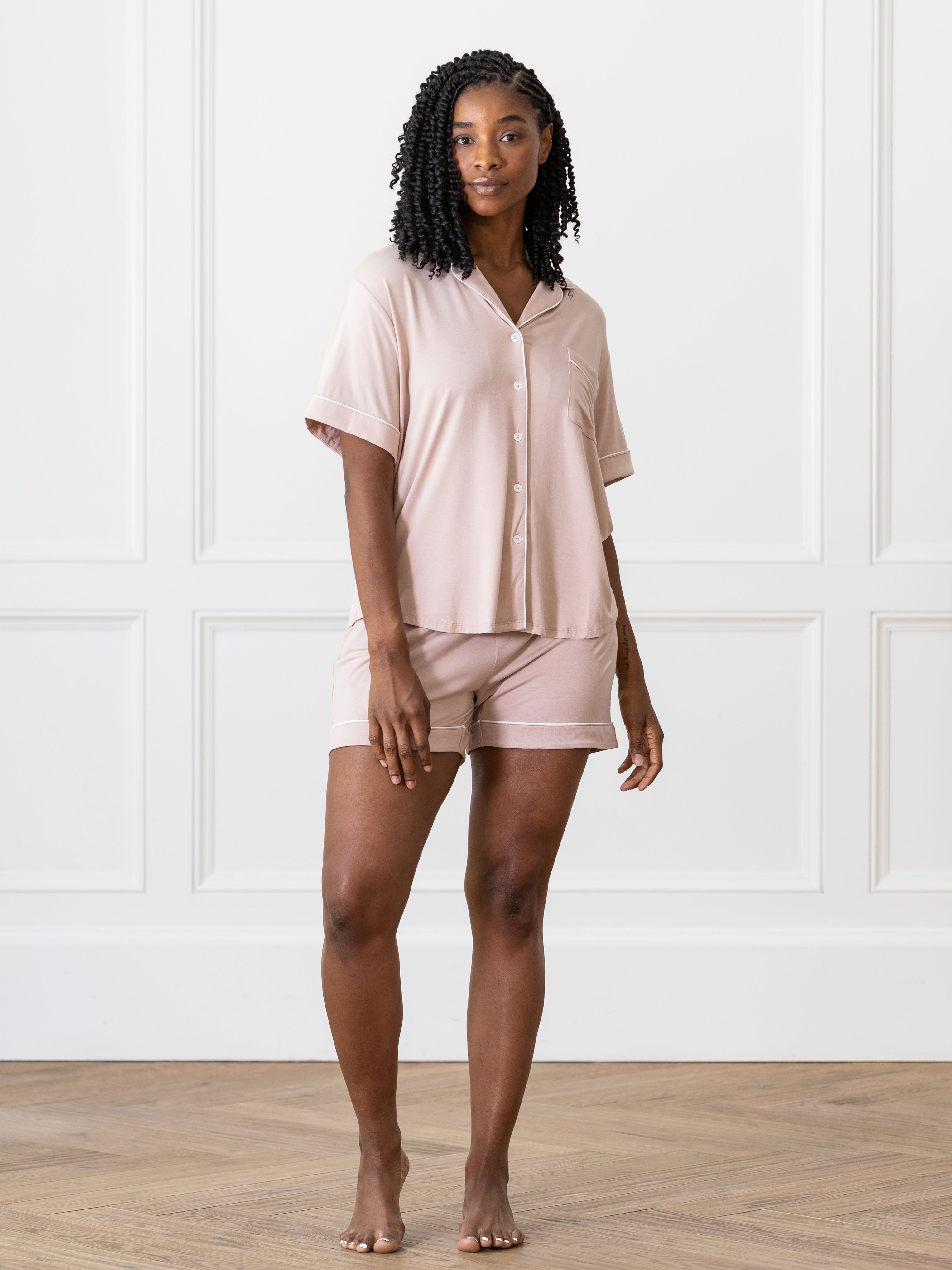 Blush Short Sleeve Pajama Set modeled by a women. The photo was taken in a light setting showing off the pajamas. |Color:Blush
