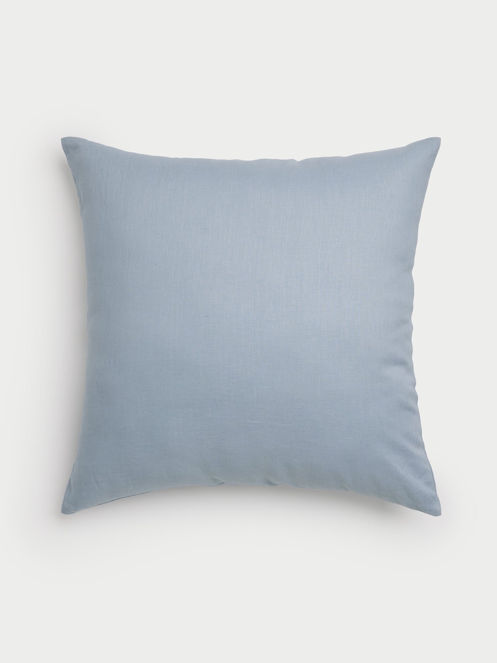 The Linen Throw Pillow by Cozy Earth, featuring a light blue shade and a simple design, is displayed against a plain white background. Its soft and smooth texture makes it an ideal addition to any home decor. |Color:Breeze|Size:26" x 26"