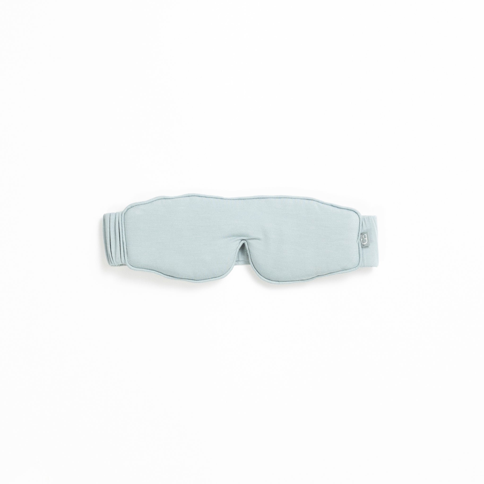 A light gray sleep mask from the Rest & Reset Bundle by Cozy Earth, featuring an adjustable strap, displayed on a white background.