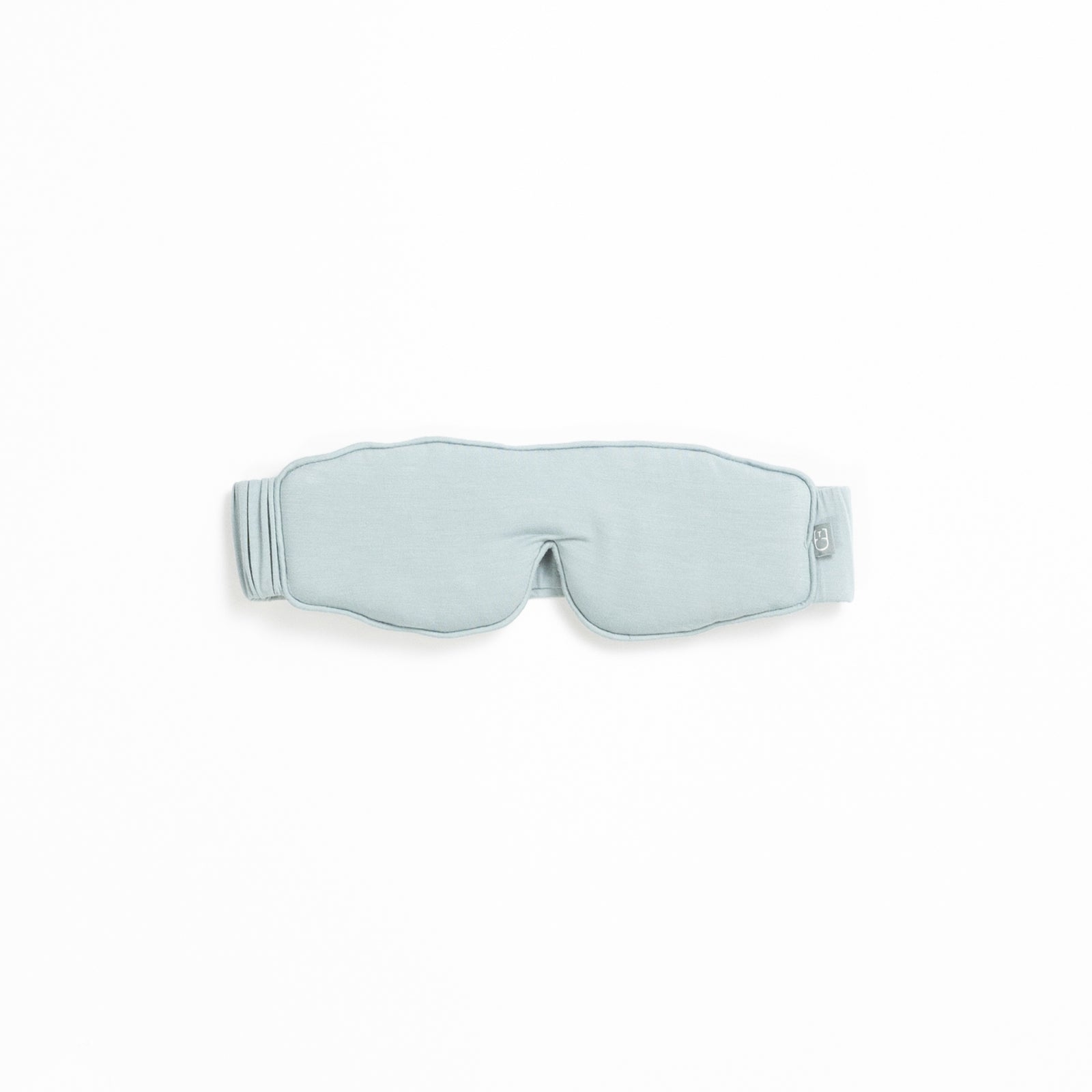 A light gray sleep mask from the Rest & Reset Bundle by Cozy Earth, featuring an adjustable strap, displayed on a white background.