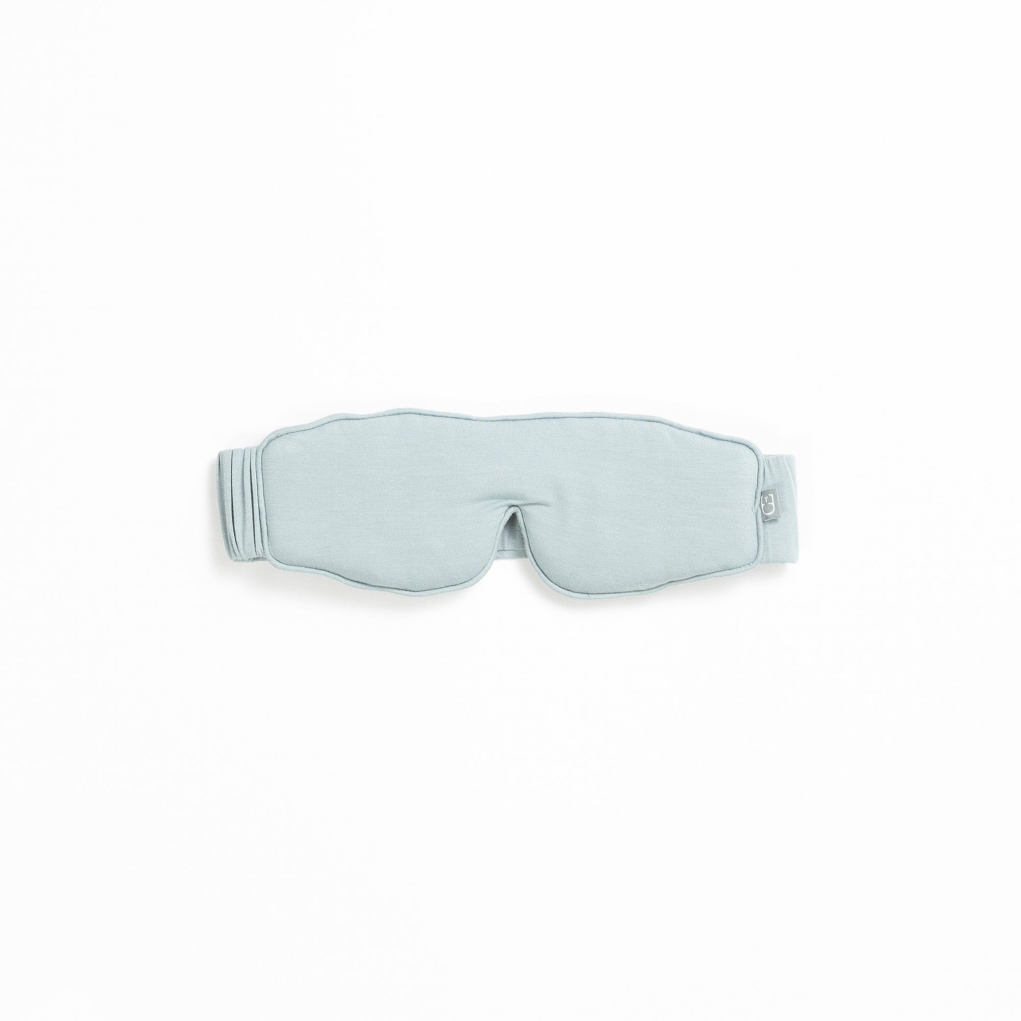 A light gray sleep mask from the Rest & Reset Bundle by Cozy Earth, featuring an adjustable strap, displayed on a white background.