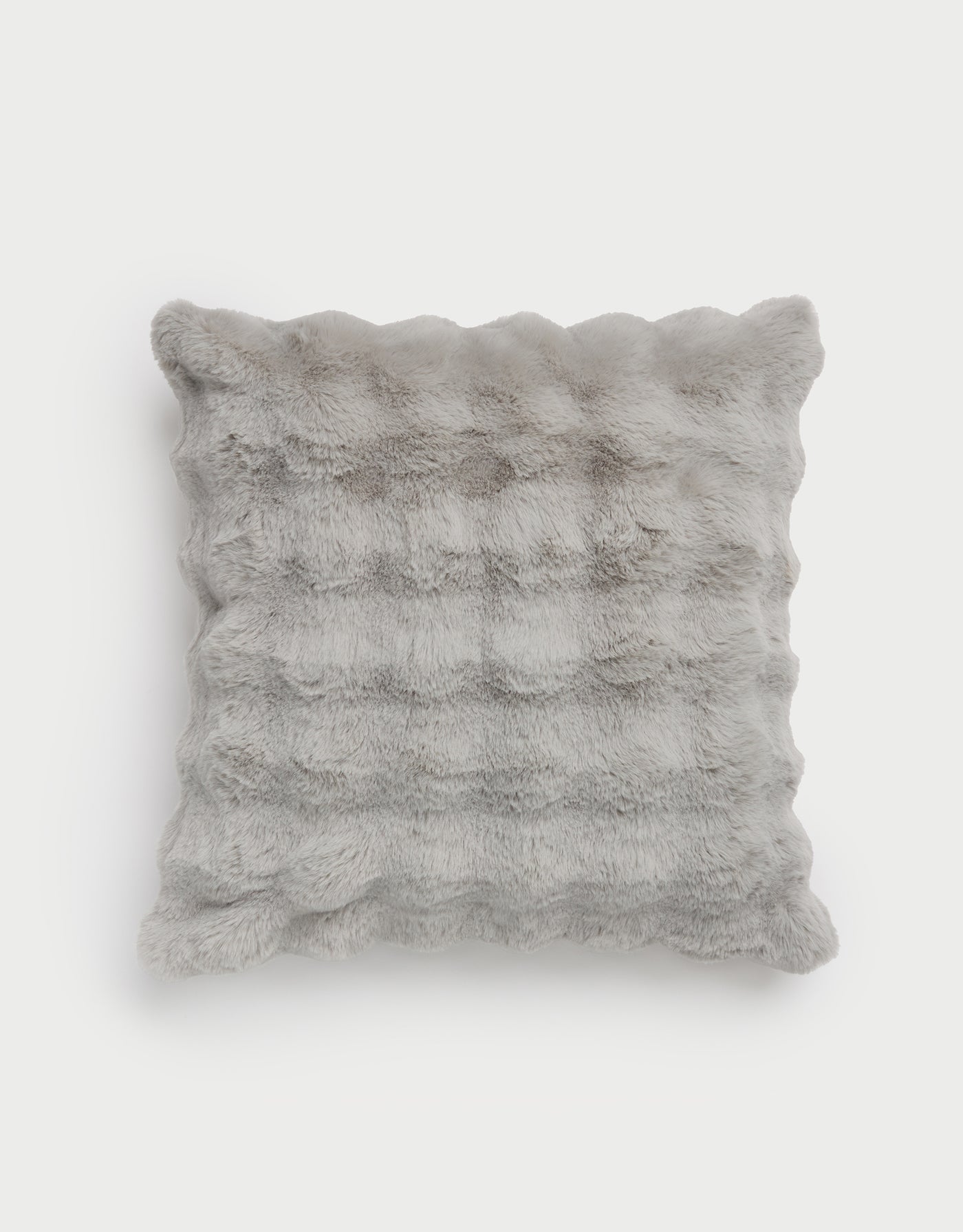 The Bubble Cuddle Pillow by Cozy Earth is a soft, square pillow with a textured, fur-like gray surface. It looks fluffy and is set against a plain white background. |Color:Light Grey