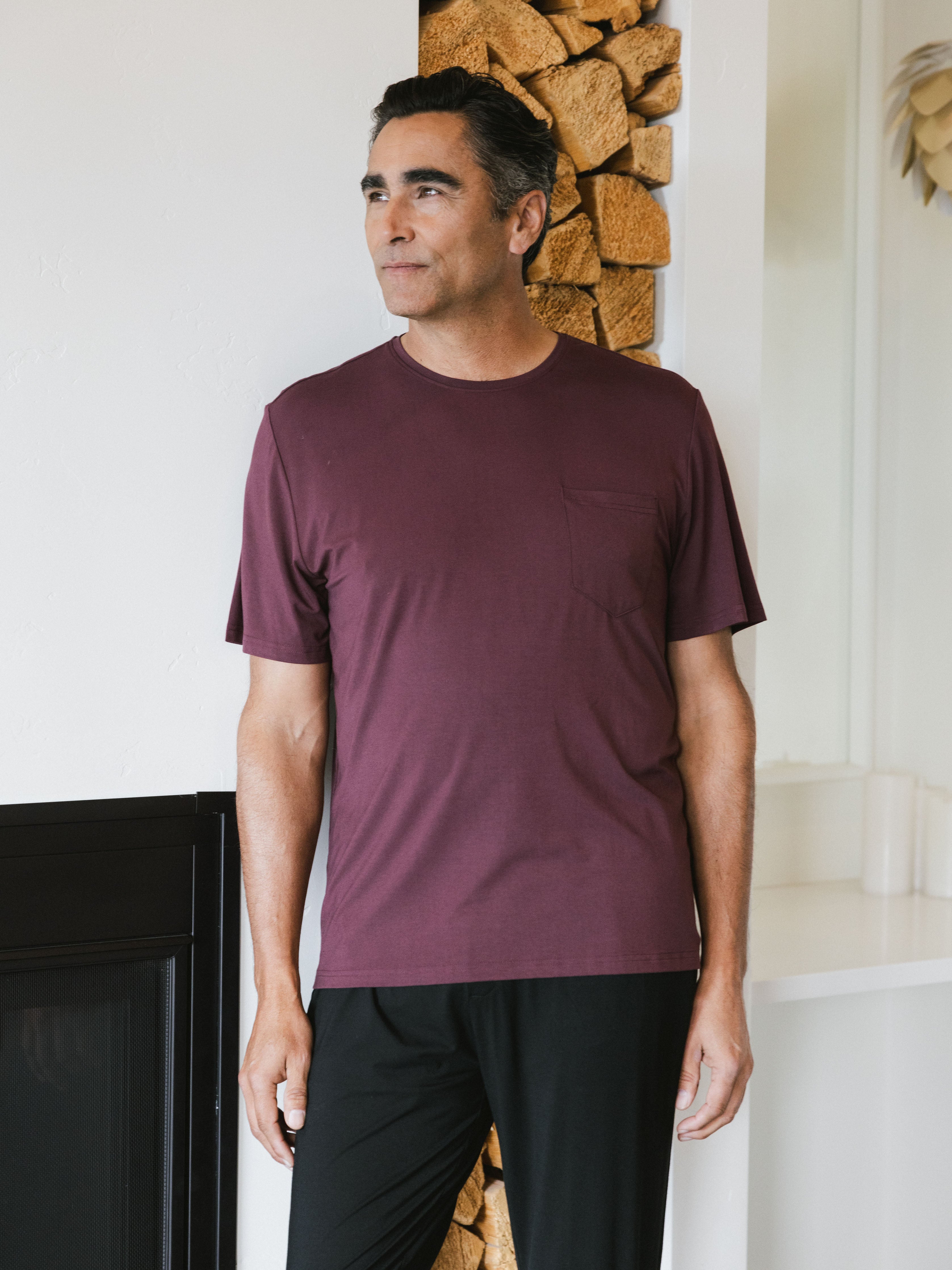 Burgundy Men's Stretch-Knit Bamboo Lounge Tee. A man is wearing the lounge tee in a well lit home.|Color:Burgundy