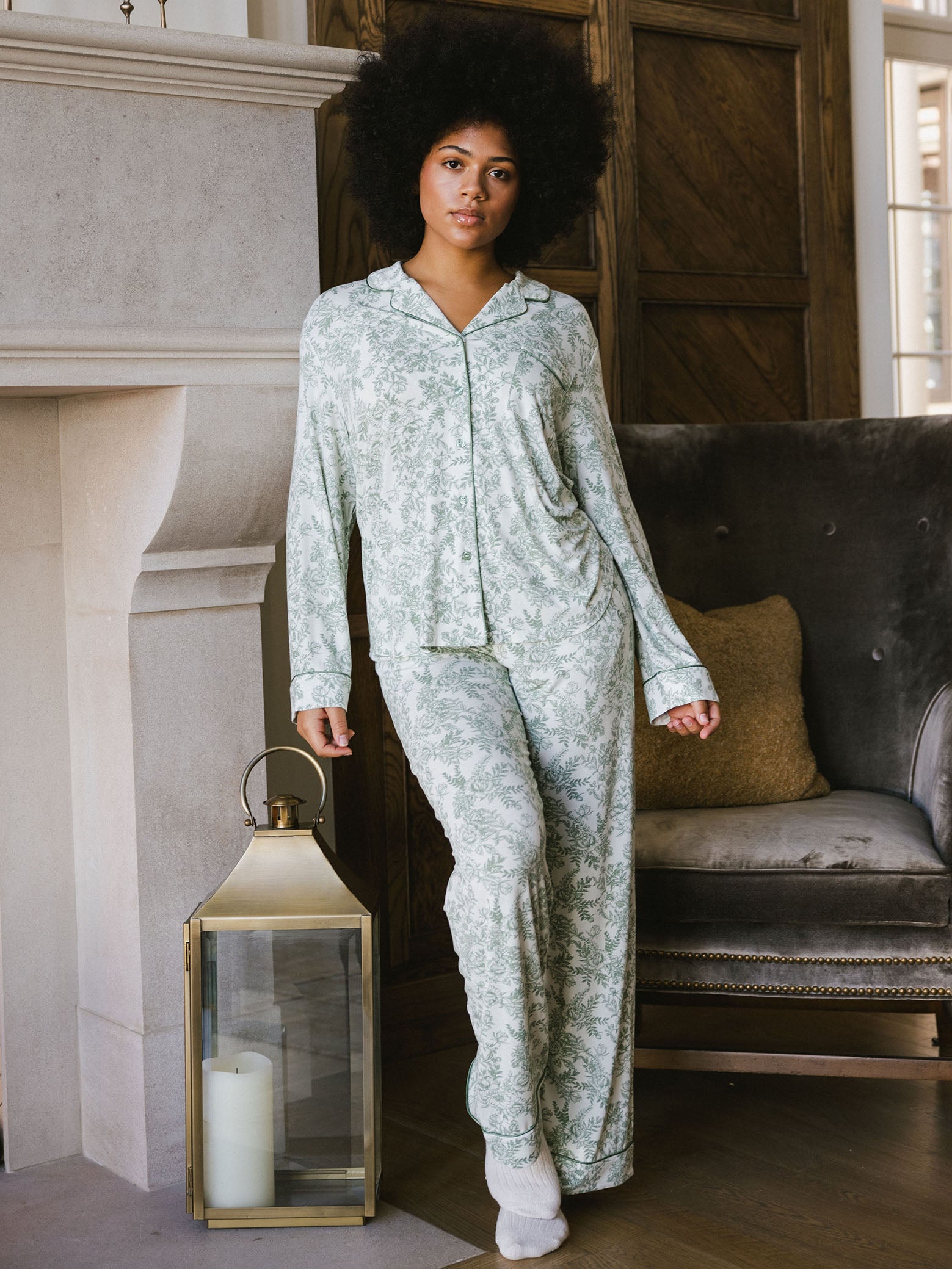 Woman standing in living room in celadon toile pajama set 