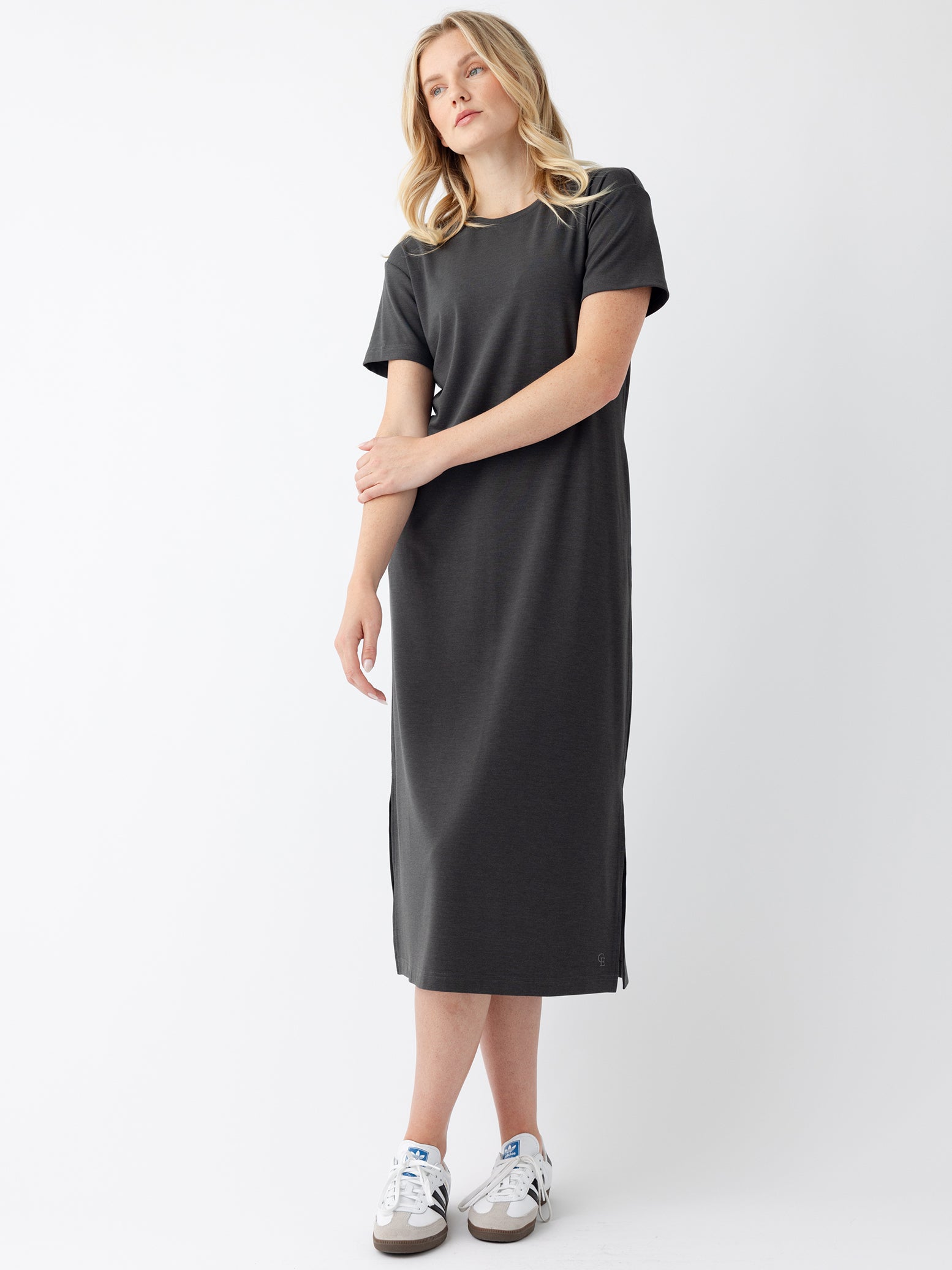 Woman in charcoal midi dress with white background 