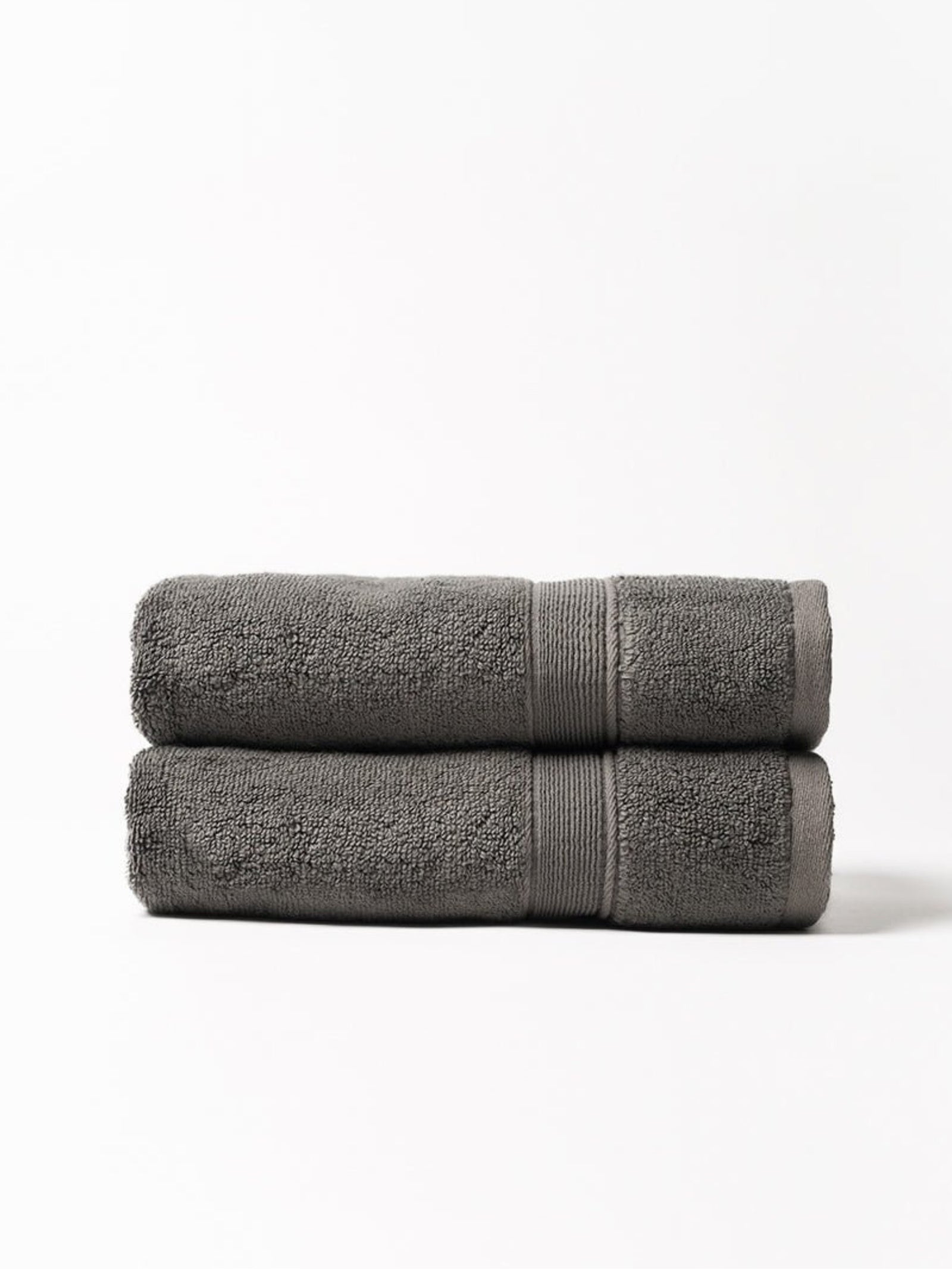 Charcoal luxe bath towels folded with white background 