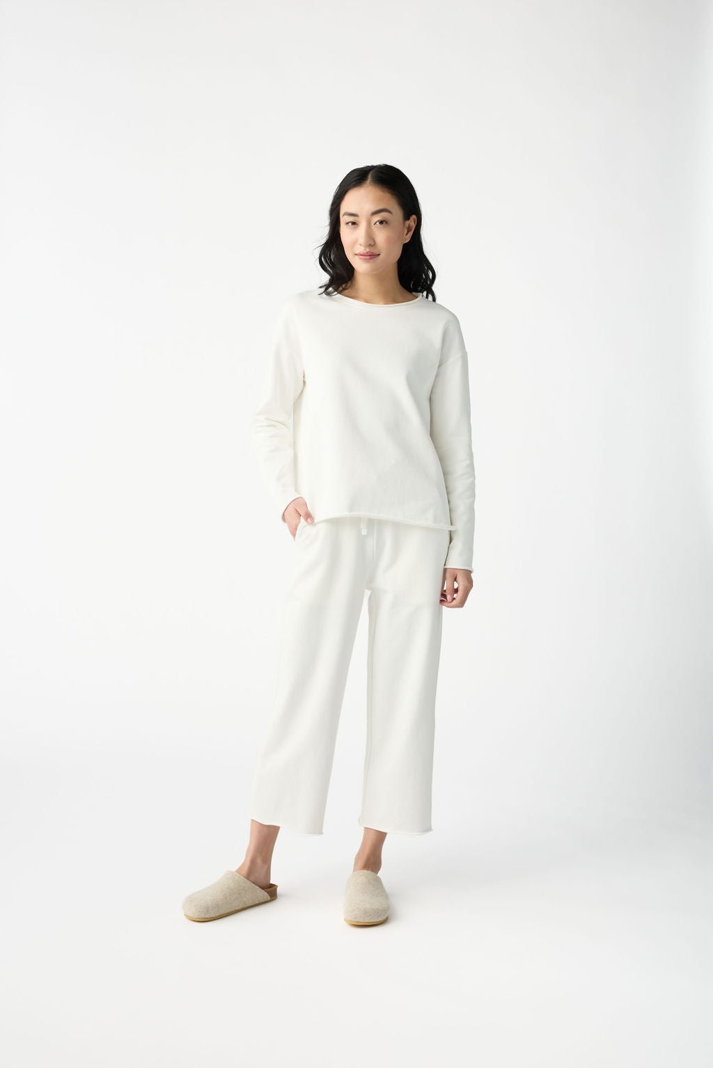 A woman with dark hair wears Cozy Earth Women's Chelsea Cropped Pant in Bone in front of a white background. |Color:Bone