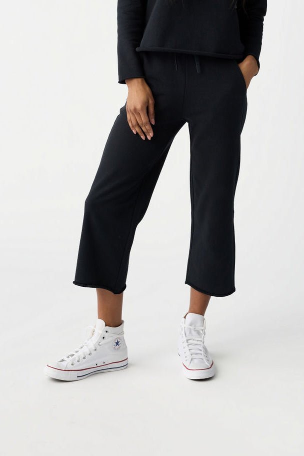 A woman pictured from the waist down wears Cozy Earth Women's Chelsea Cropped Pant in Jet Black in front of a white background. |Color:Jet Black