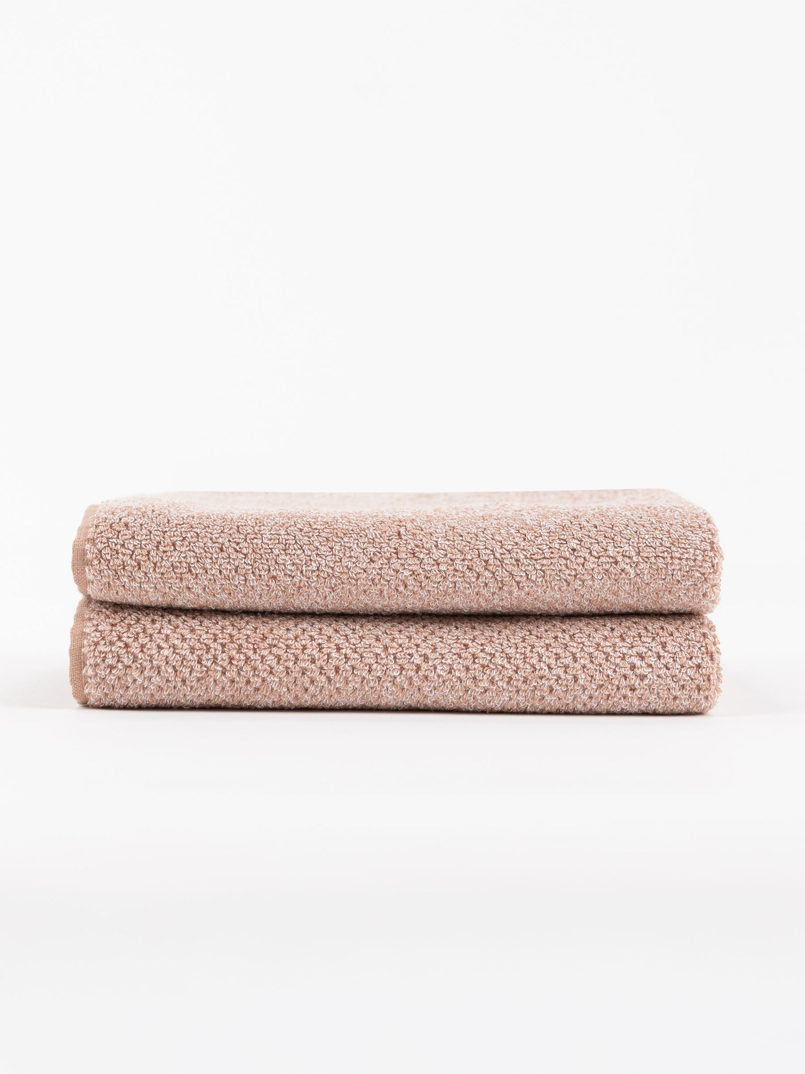 A pair of Nantucket Bath Towels in Heathered Clay are stacked. 