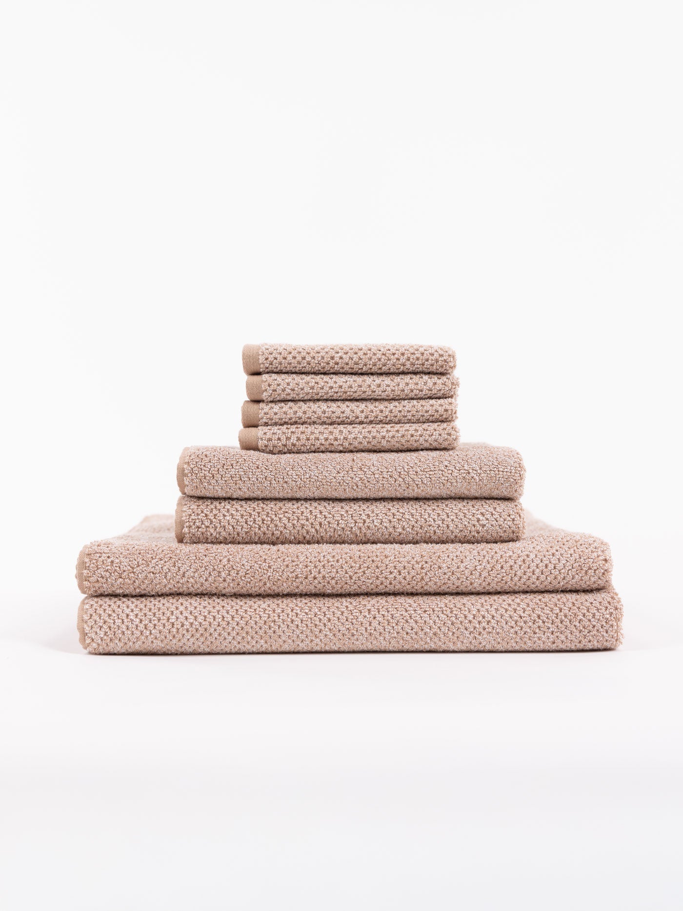 A stack of Nantucket Bath Towels sit in front of a white background. 