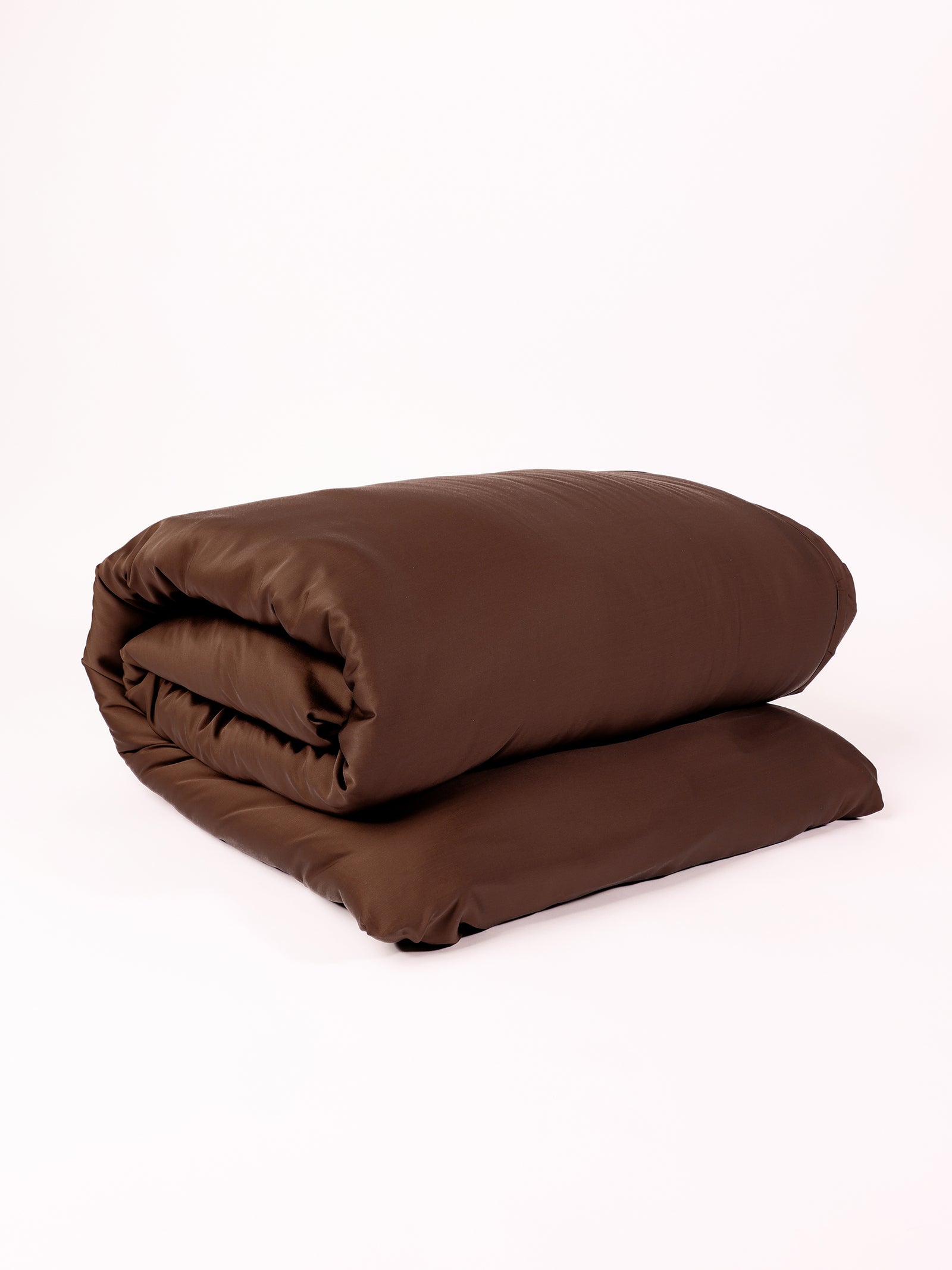 A neatly folded Bamboo Duvet Cover by Cozy Earth in dark brown is displayed against a plain white background. The fabric appears smooth and slightly shiny, indicating a soft and plush texture. 