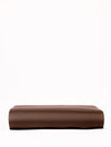 A neatly folded Cozy Earth Bamboo Fitted Sheet in a soft brown shade is placed against a plain white background. The sheet features a smooth texture and clean edges, enhancing its tidy appearance. |Color:Coffee