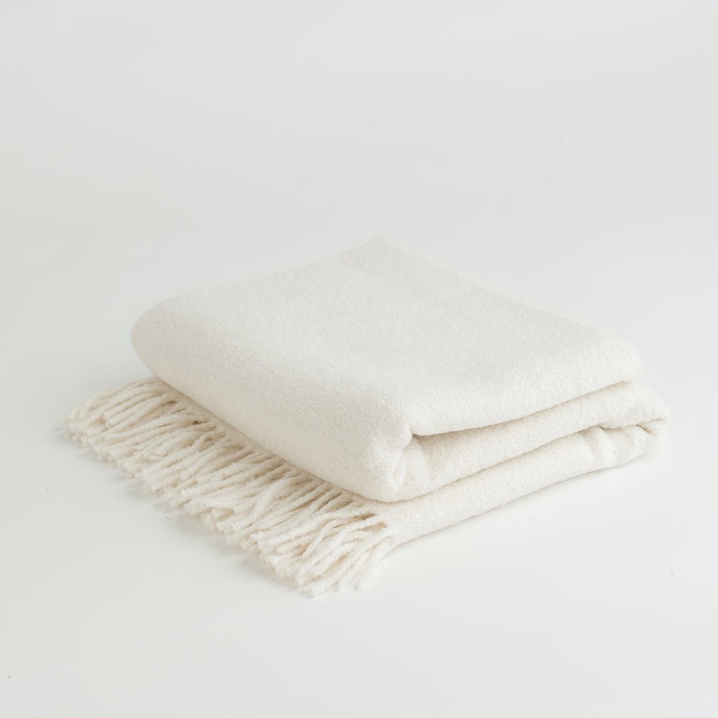 Creme boucle throw folded with white background 