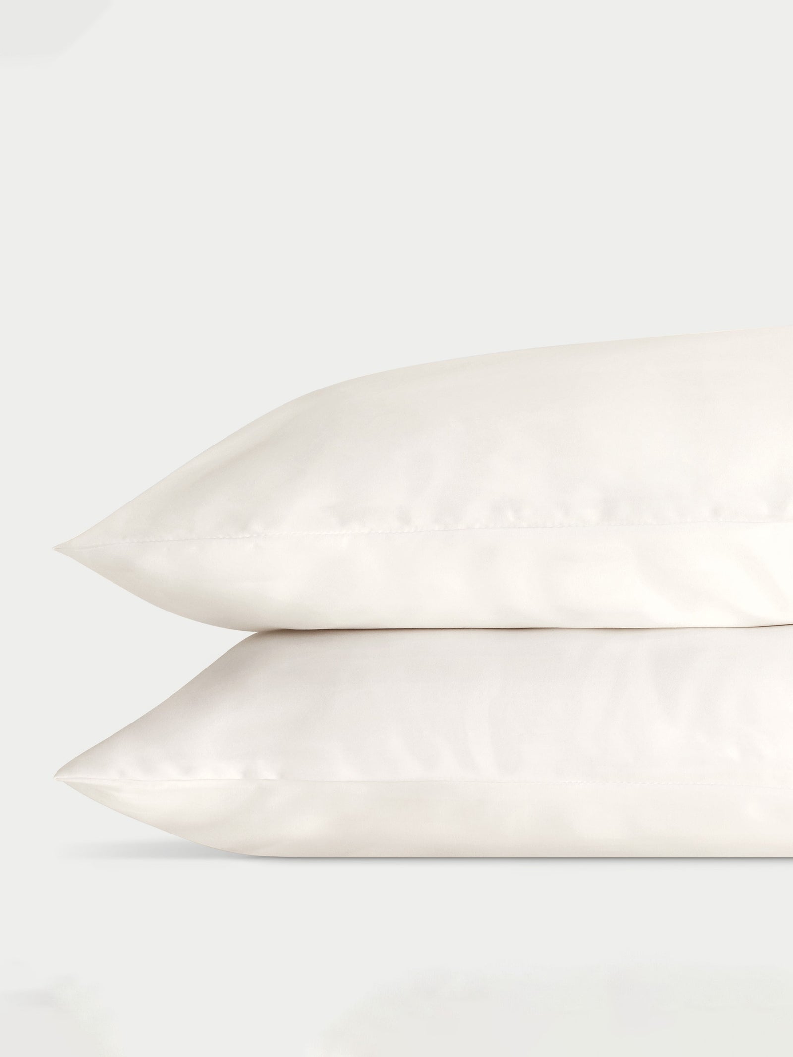 Two creme pillowcases with a plain background standard/king/body