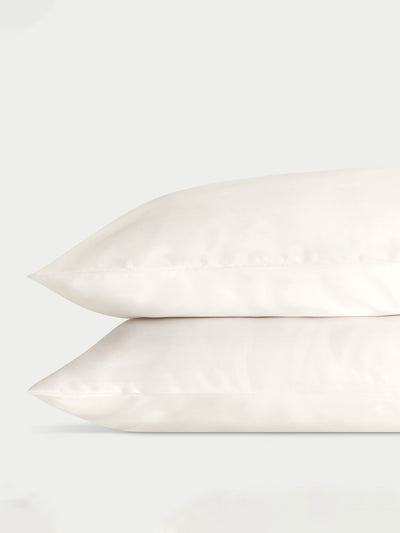 Two creme pillowcases with a plain background standard/king/body