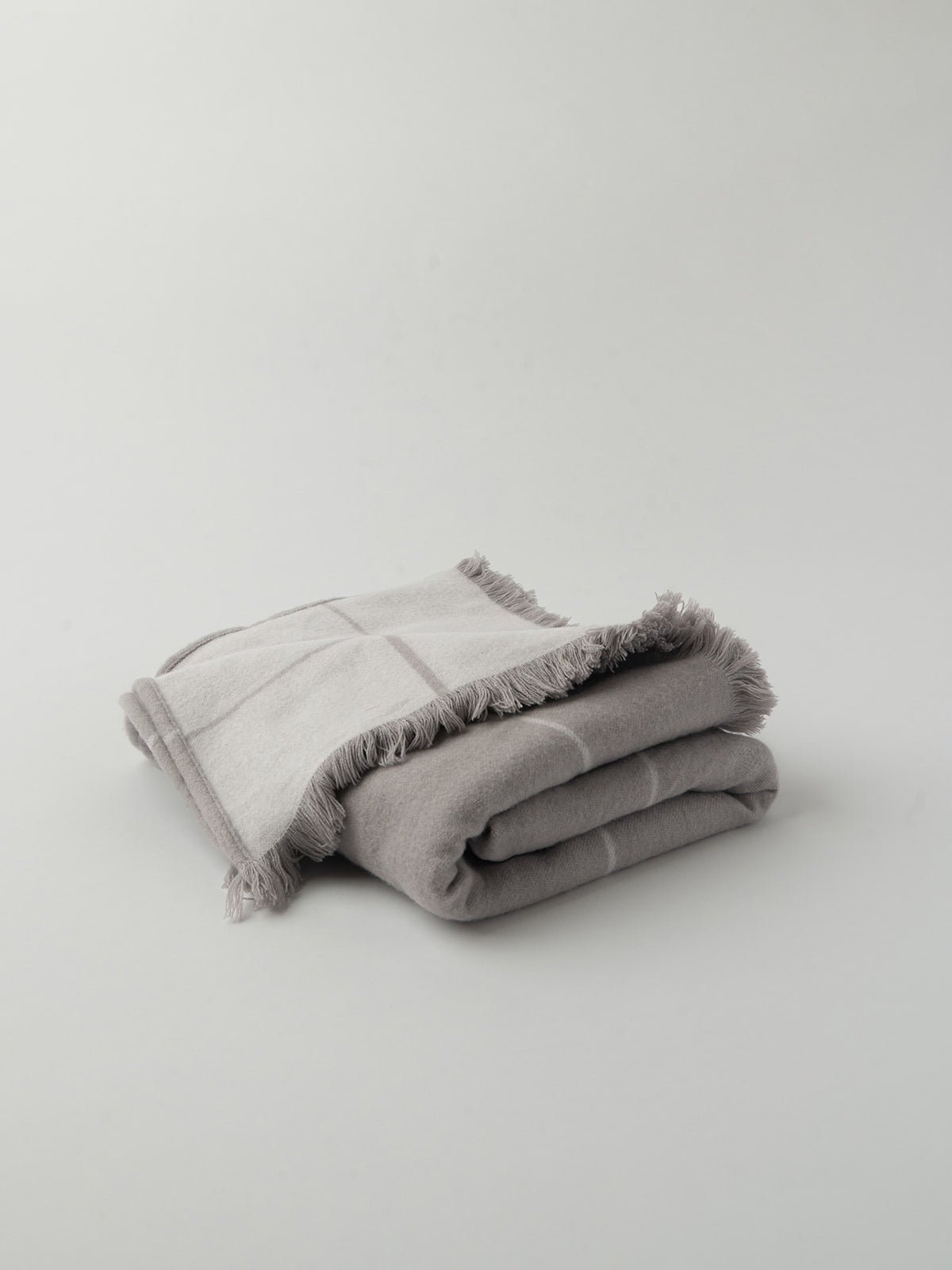 Grey windowpane blanket half folded showing tasseled edge |Color:Dove Grey/Light Grey