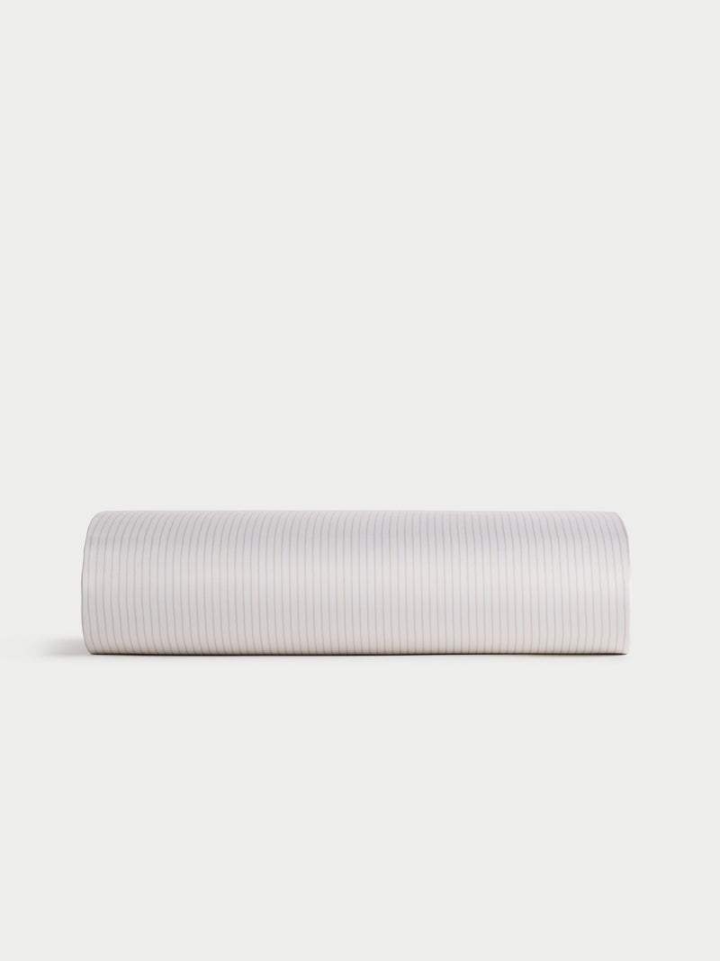 A Bamboo Duvet Cover by Cozy Earth, featuring a subtle striped pattern in shades of white and light beige, displayed against a plain white background.