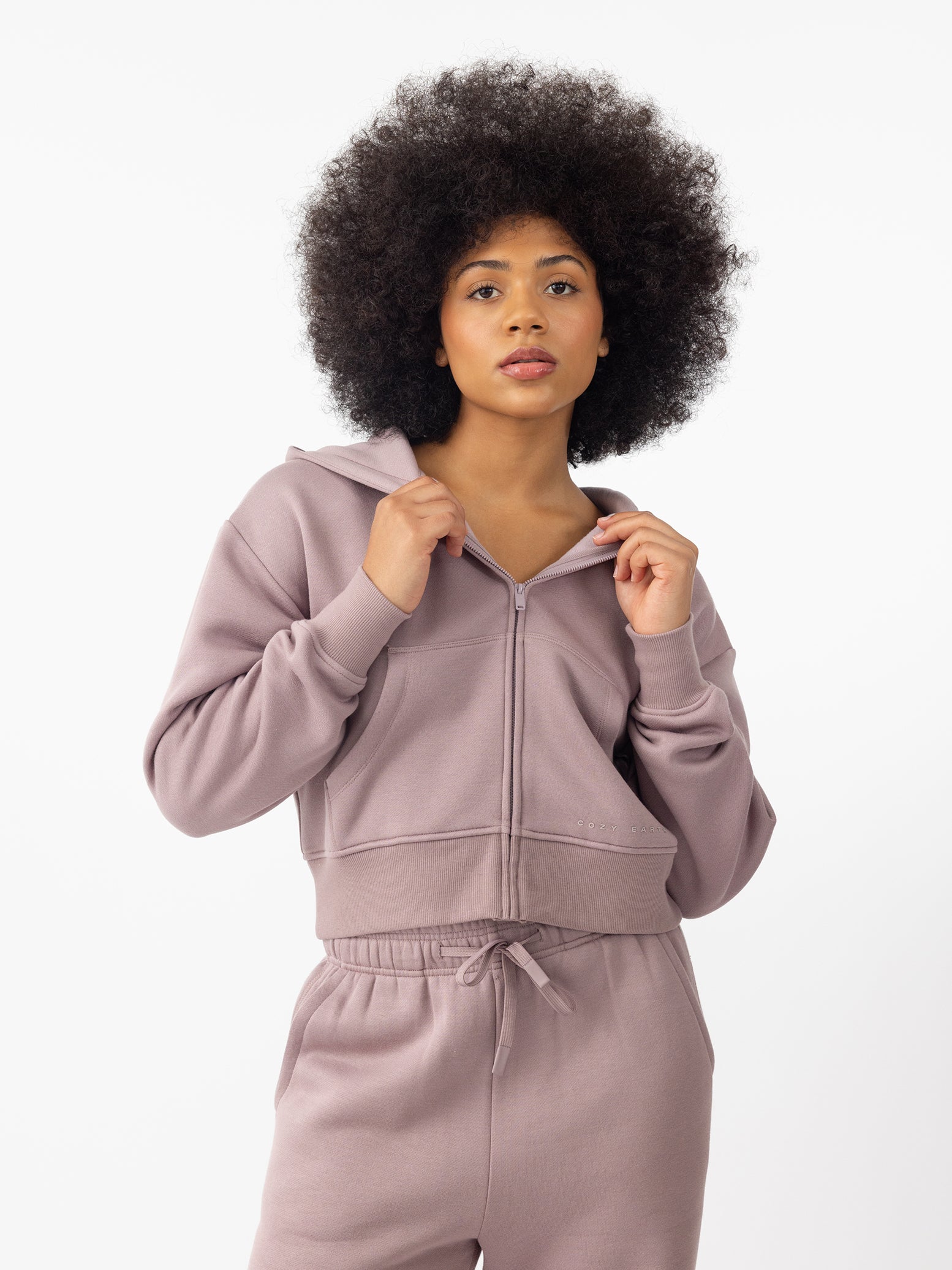 Woman wearing Dusty Orchid CityScape Cropped Full Zip with white background 