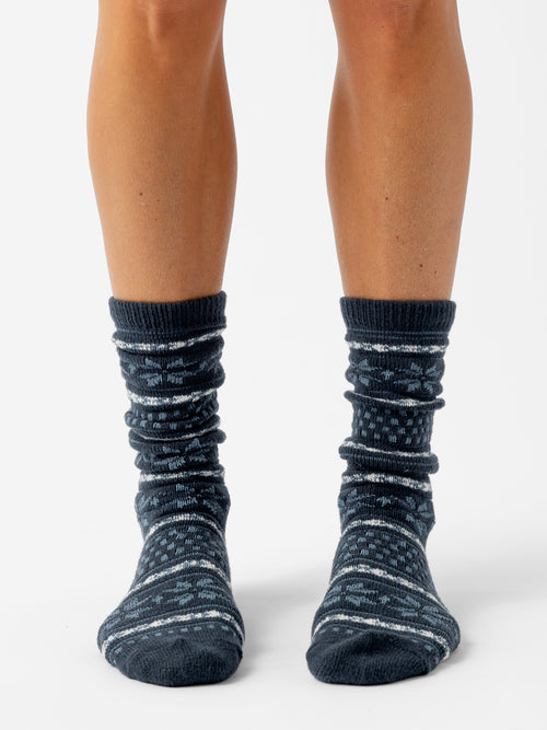 A person stands facing forward with a white background wearing Snowflake Plush Lounge Socks in Eclipse |Color:Eclipse