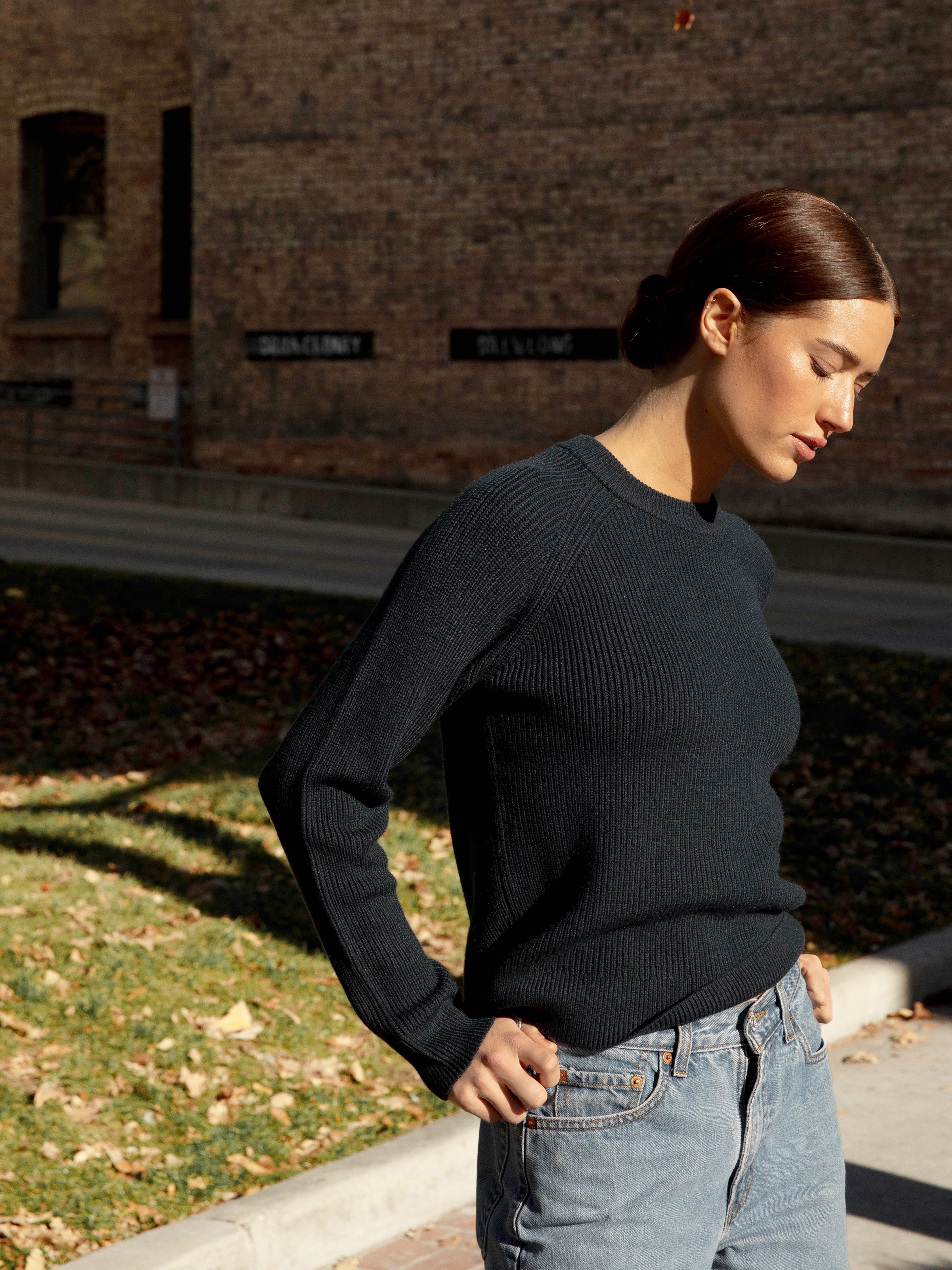 Woman wearing eclipse classic crewneck and jeans outside 