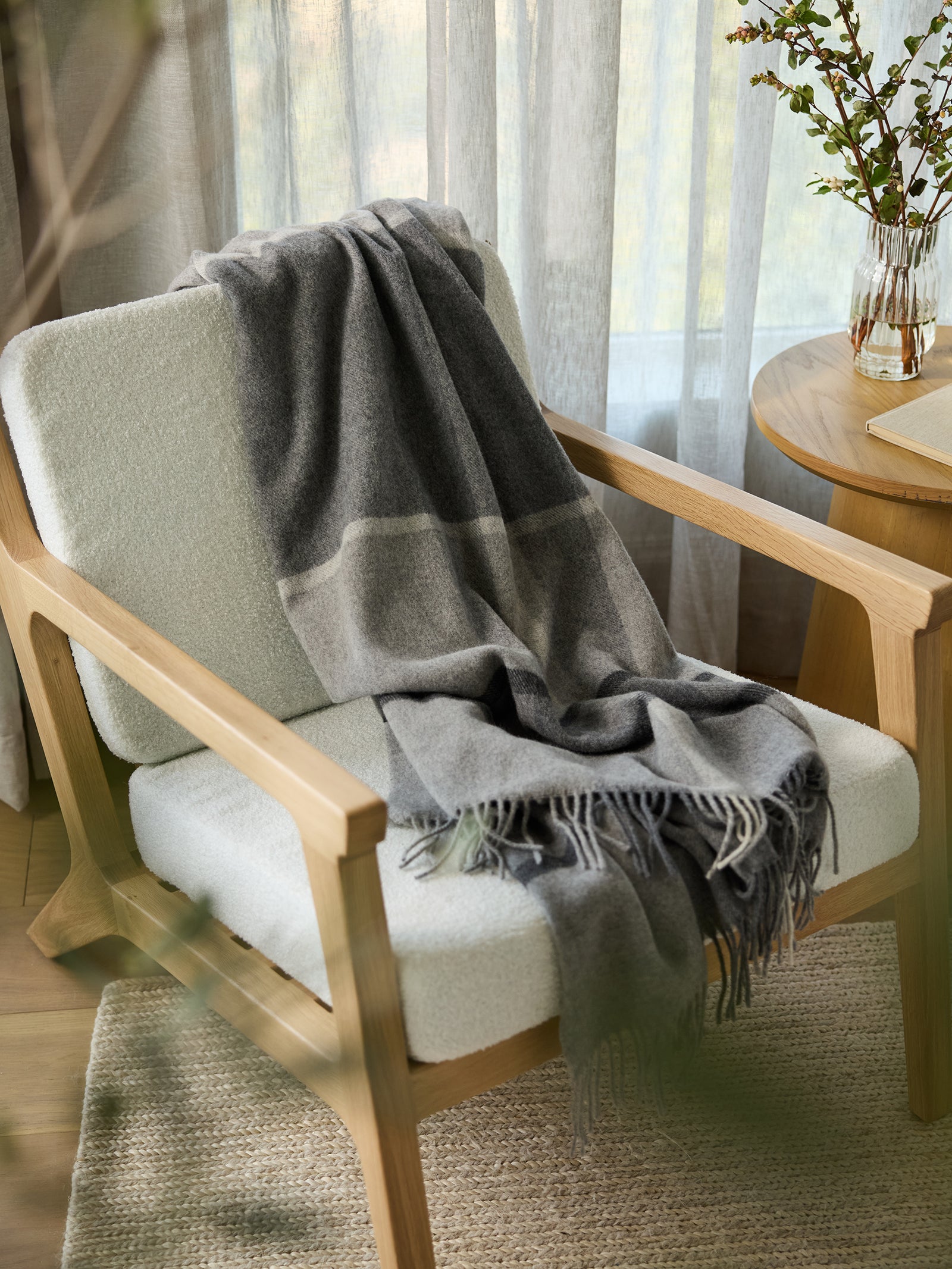 Grey Lucca throw draped over accent chair 