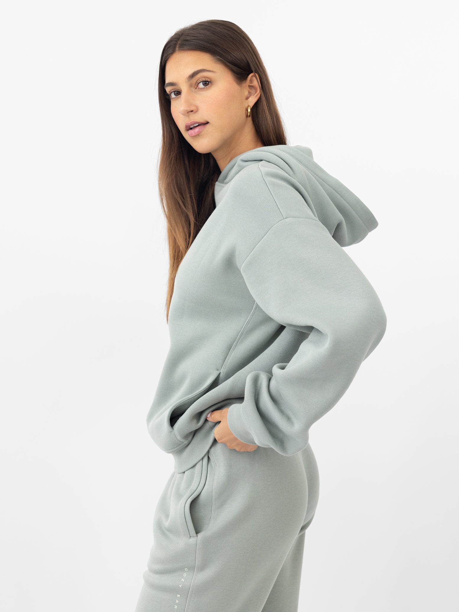 Sid eview of woman wearing haze cityscape hoodie with white background |Color:Haze