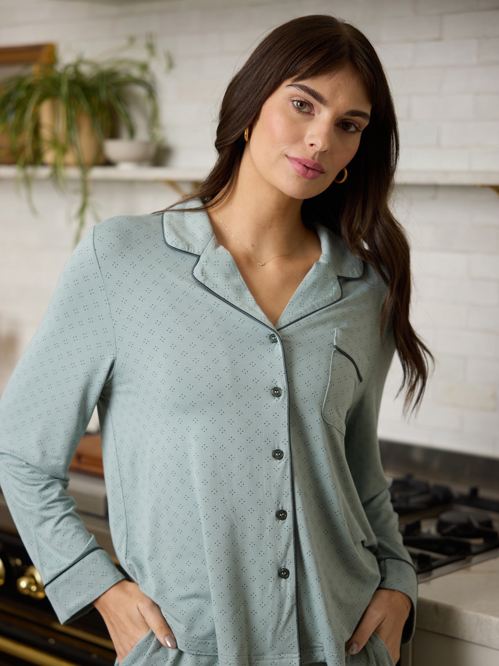 Woman standing in kitchen wearing haze diamond dot pajama top 