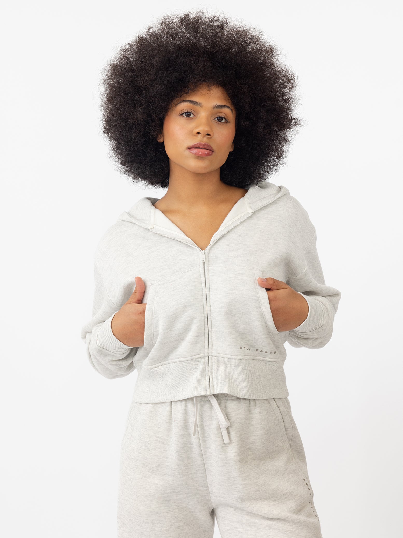 Woman wearing Heather Grey CityScape Cropped Full Zip with white background |Color: Heather Grey