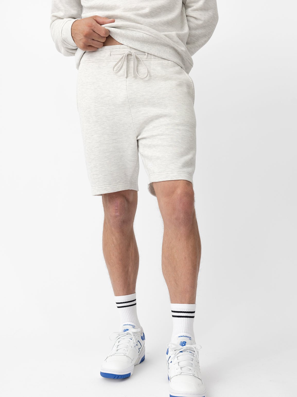 Man wearing heather grey cityscape shorts with white background 
