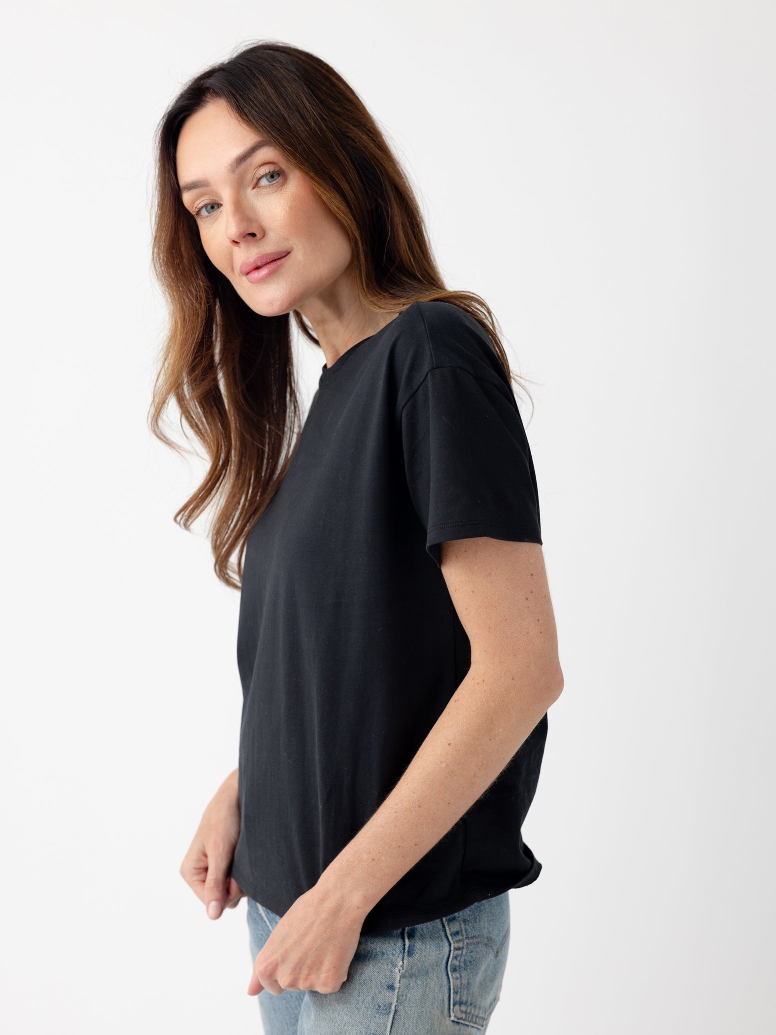 Woman wearing black tee with white background 