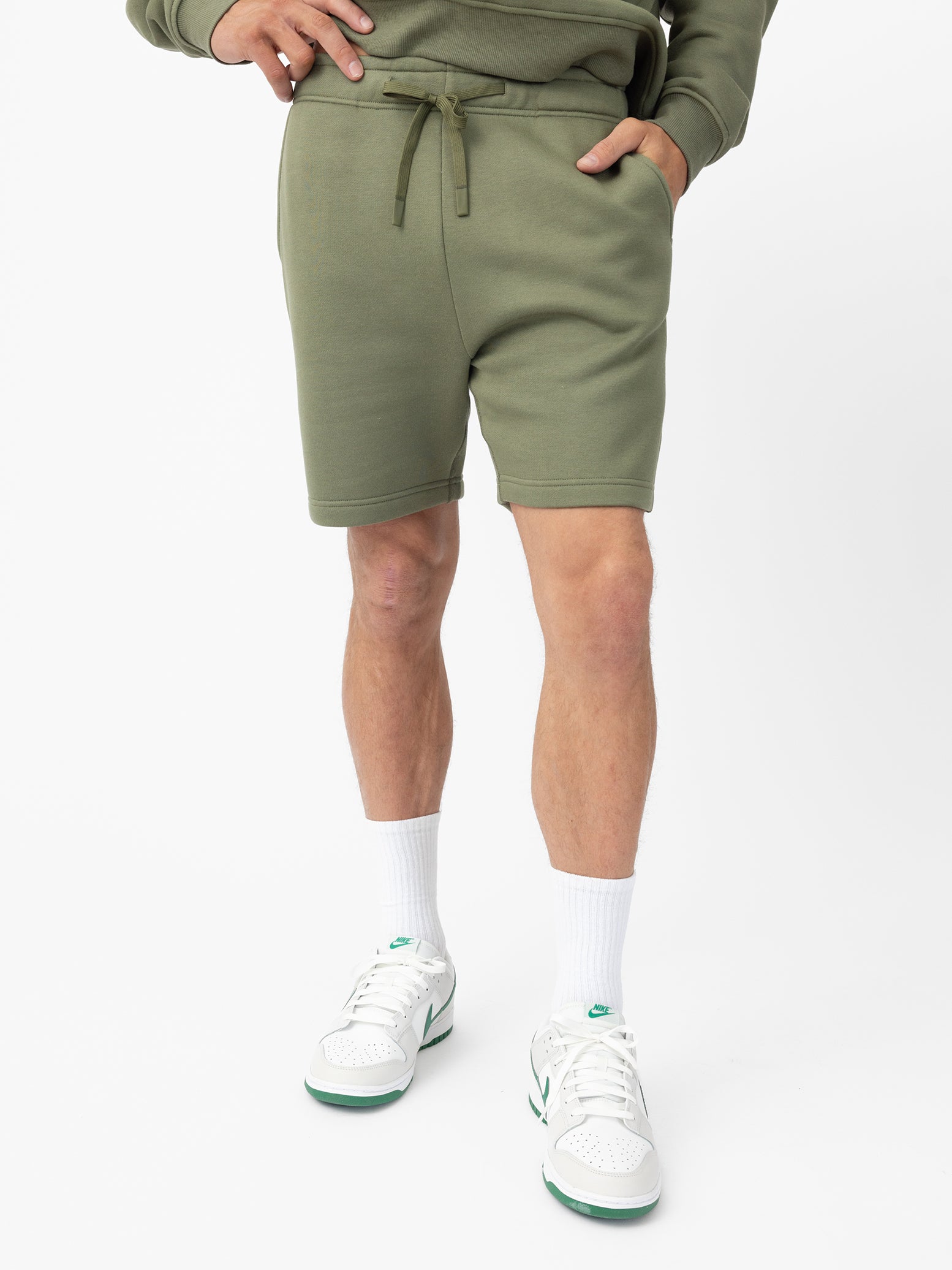 Man wearing Juniper CityScape Shorts with white background |Color: Juniper