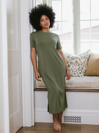 Juniper Bamboo Midi Dress modeled by a woman. The photo was taken in a high contrast setting, showing off the colors and lines of the dress. |Color: Juniper