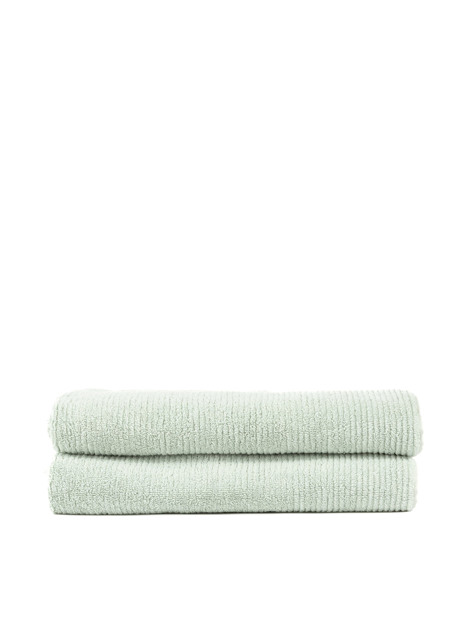 Two folded Ribbed Terry Bath Sheets by Cozy Earth, in a light green hue, are stacked on top of each other against a white background. These towels feature a textured appearance and look soft and plush. 