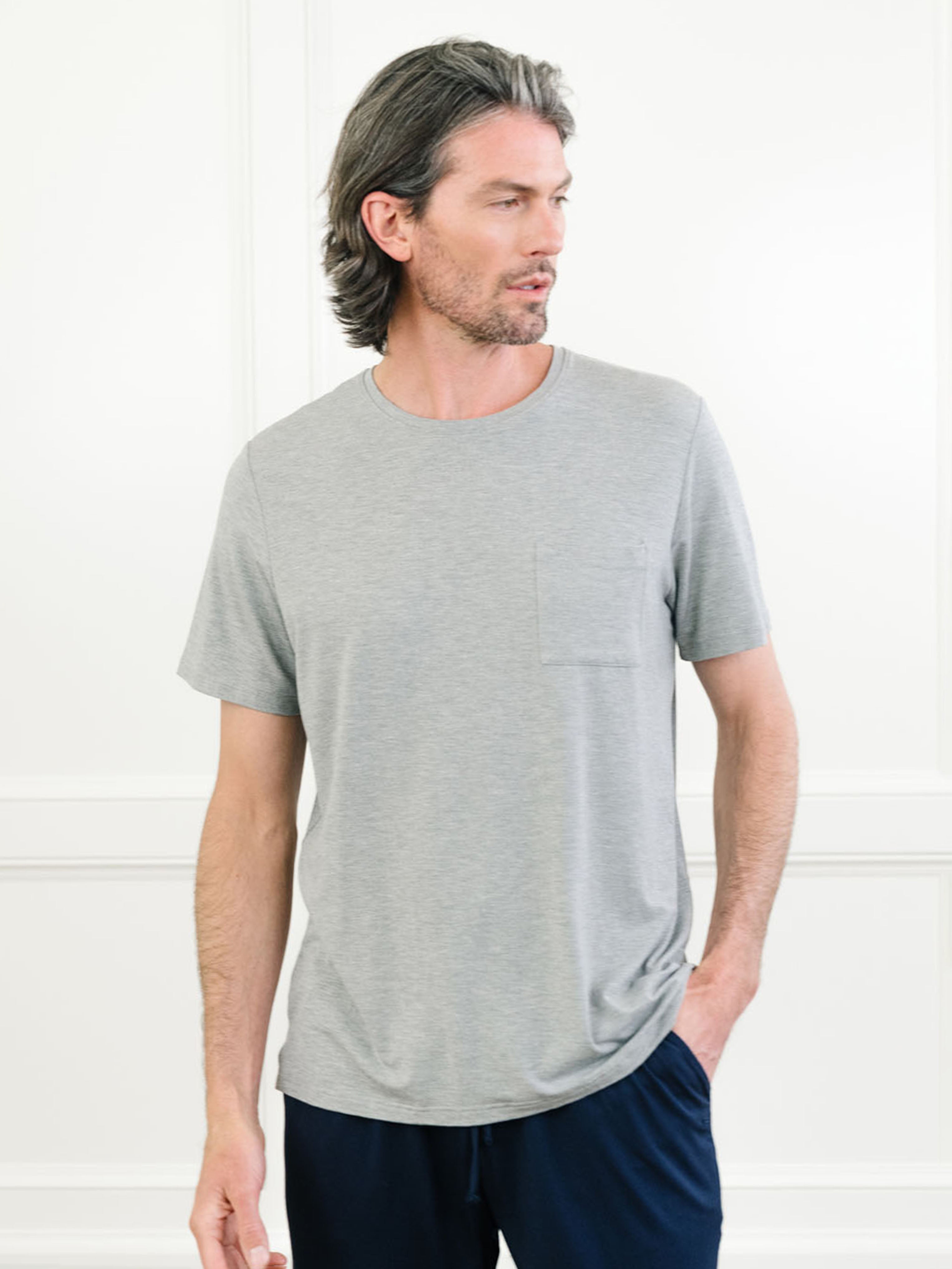 Heather Grey Men's Stretch-Knit Bamboo Lounge Tee. A man is wearing the lounge tee in a well lit home.|Color:Heather Grey
