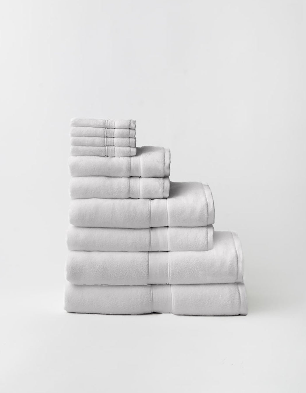Stack of Cozy Earth Complete Luxe Bath Bundle is light gray on a white background 