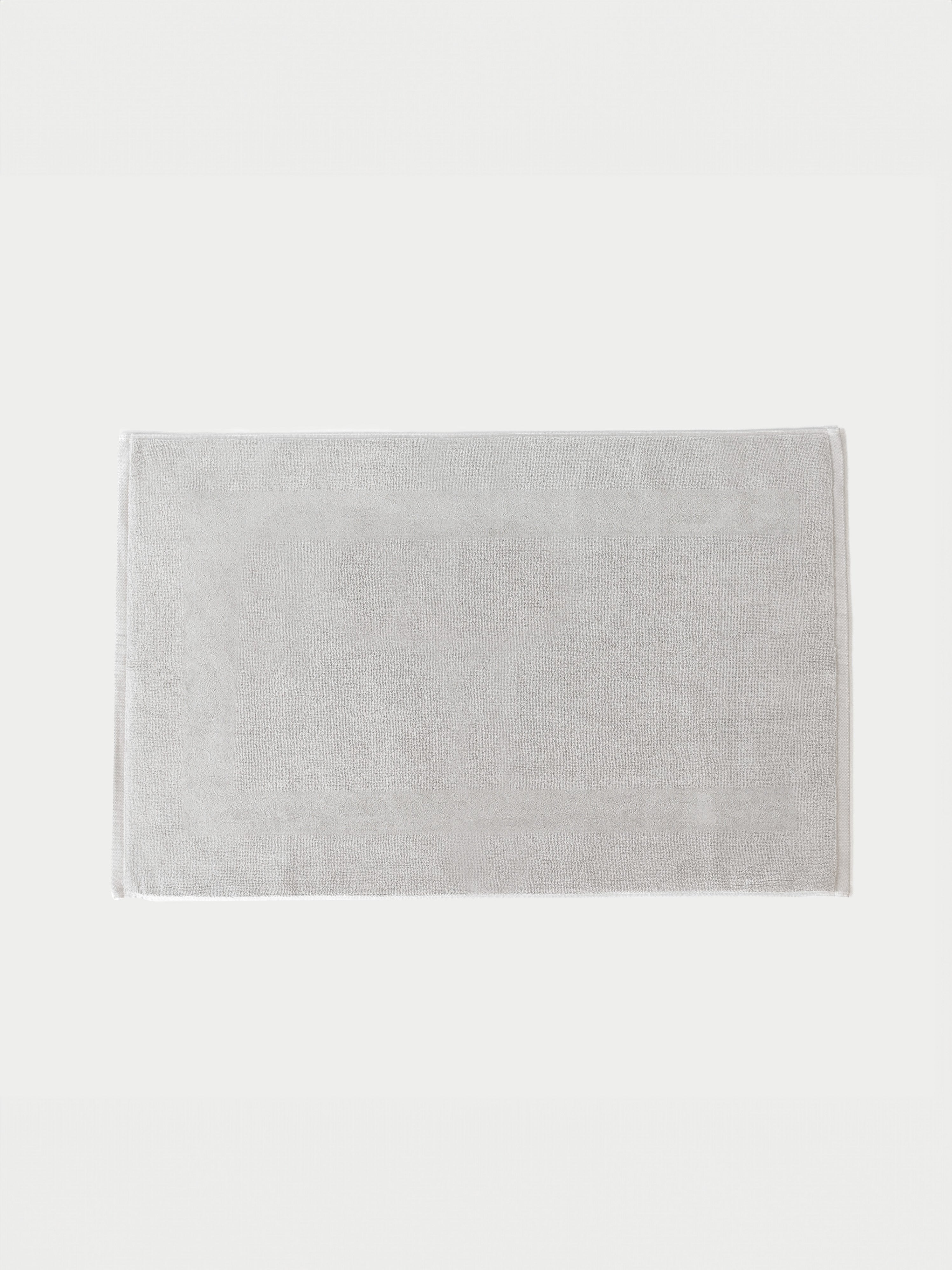 Light Grey looped terry bath mat resting on crisp background.