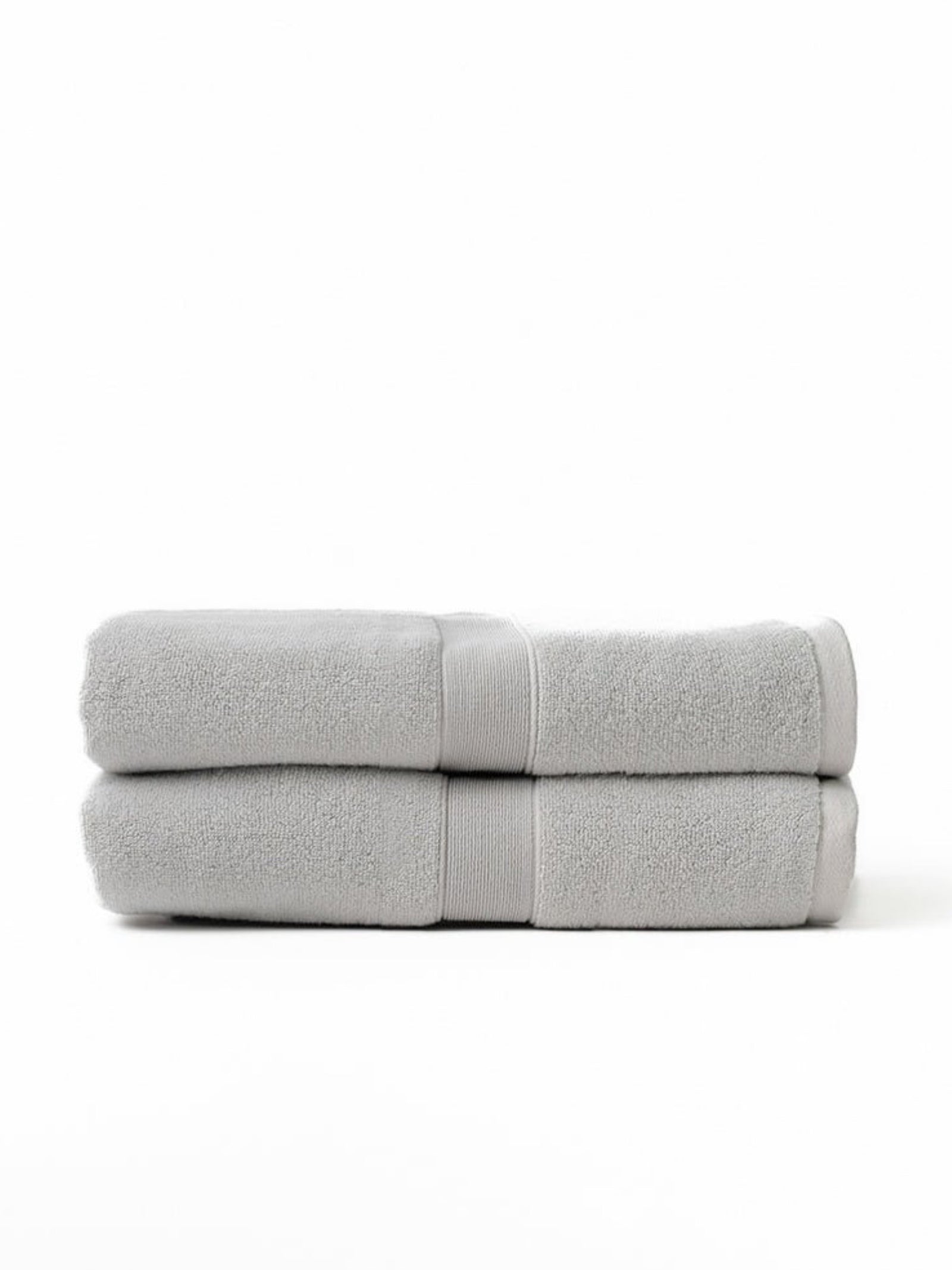 Two luxe bath sheets folded with white background 