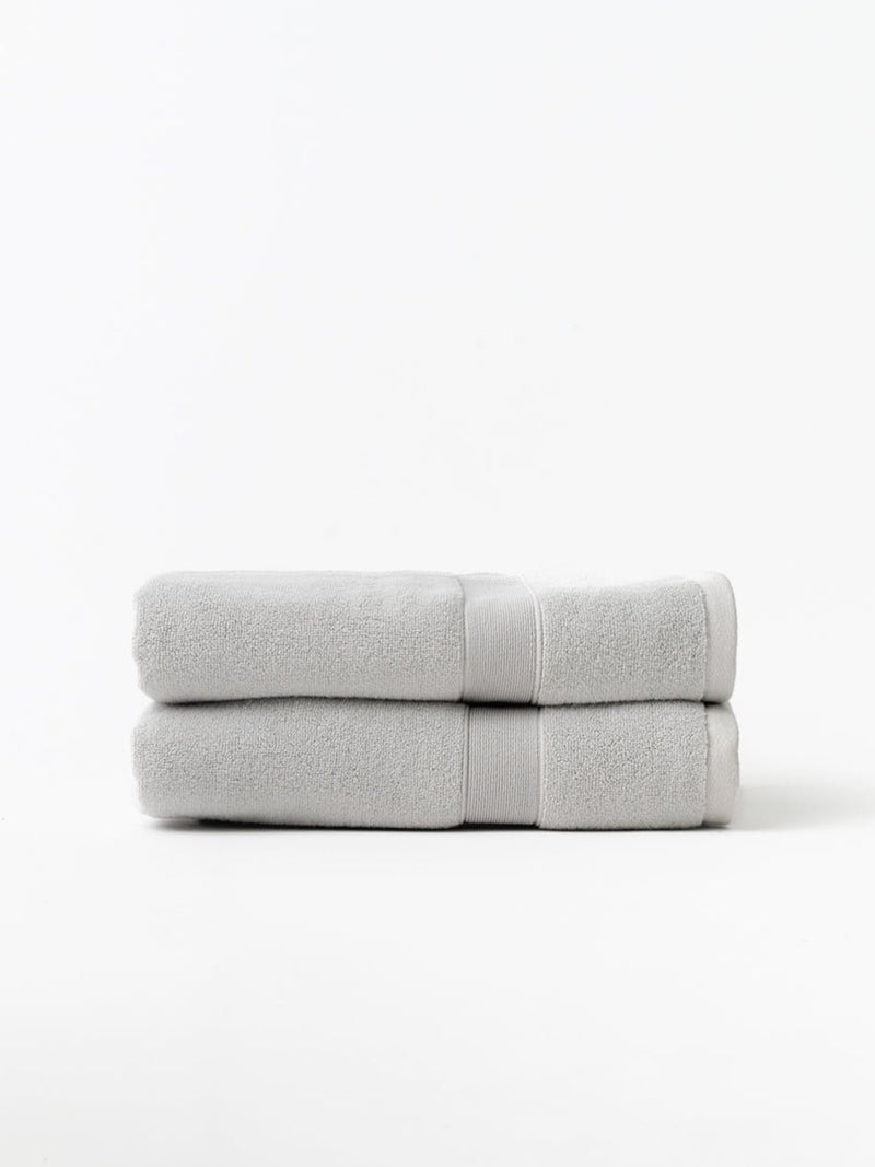 Light grey luxe bath towels folded with white background